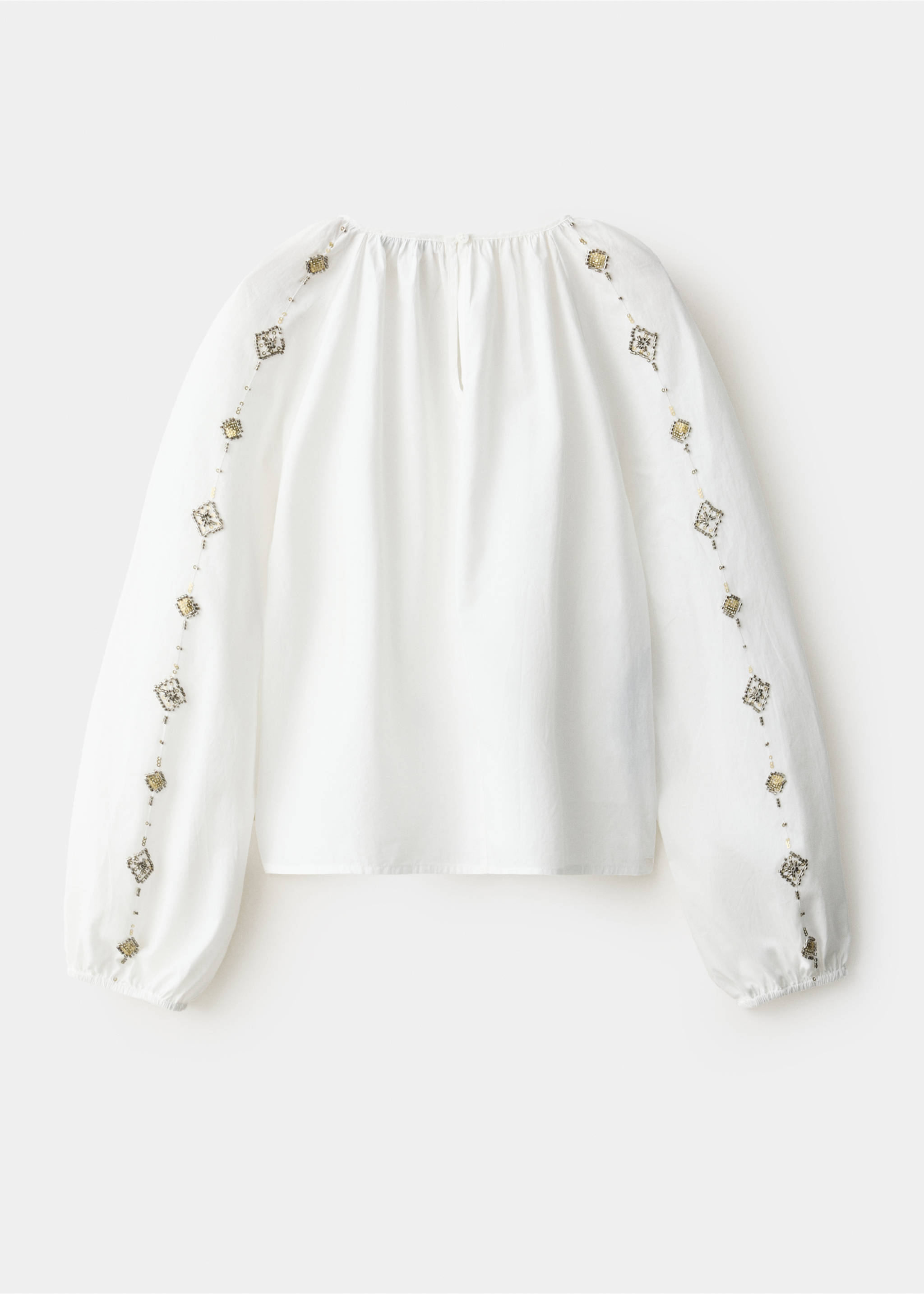 White blouse with beaded long sleeves, shown from the back., White. Ref: 37039221-00.