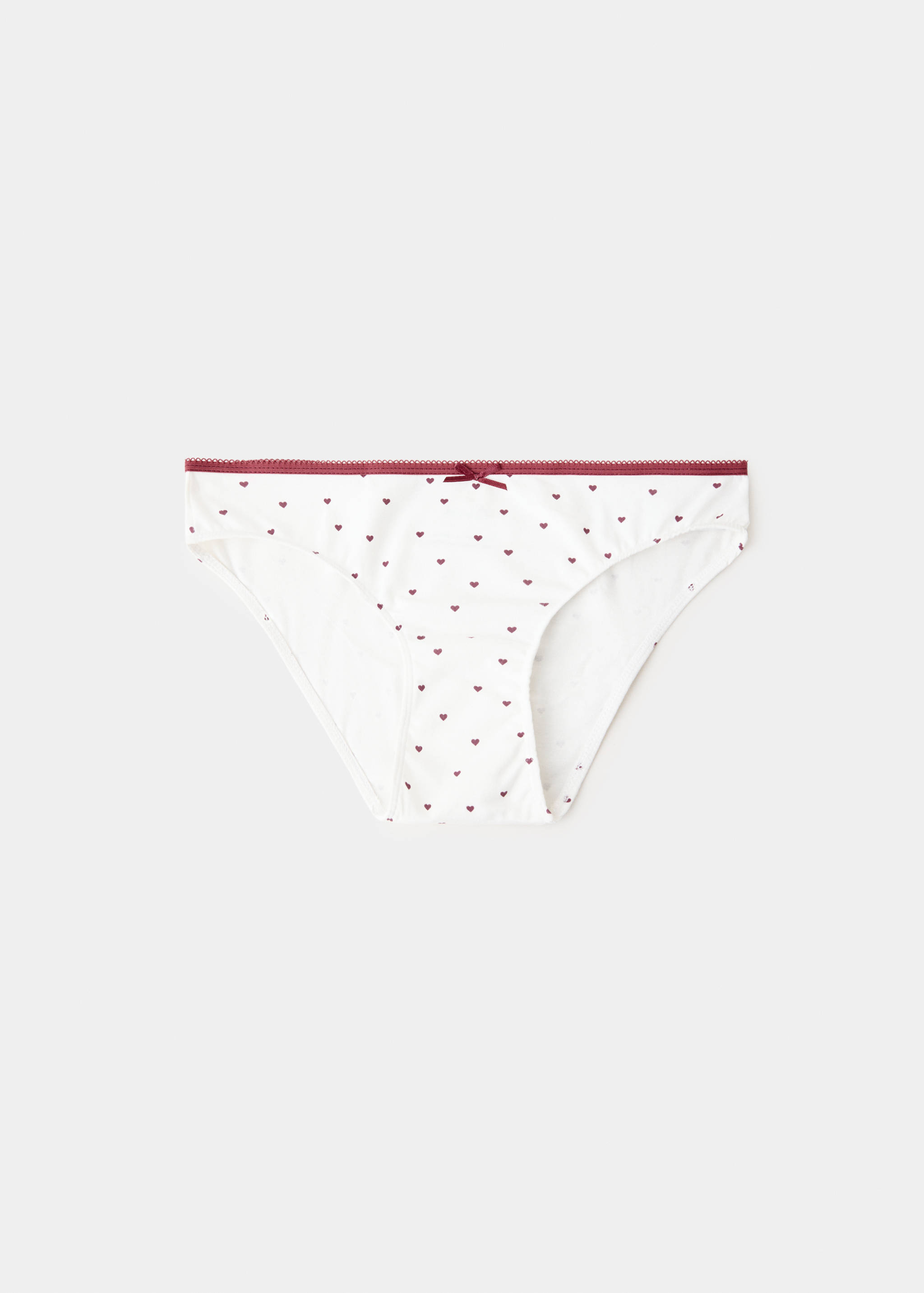 White briefs with a red heart print and elastic waistband.