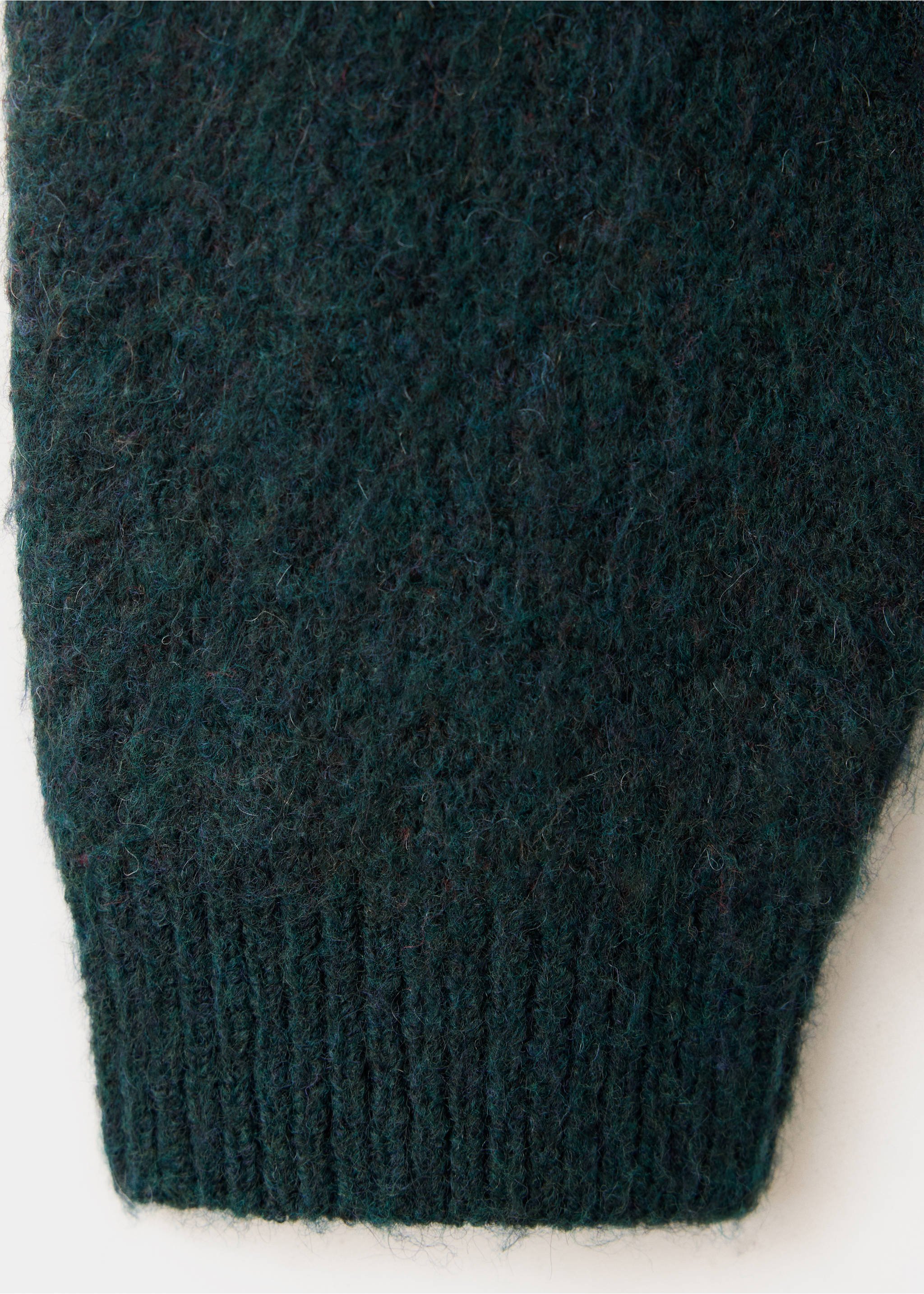 Close-up of a dark green sweater fabric showing its fuzzy texture and ribbed cuff., Dark Green. Ref: 37039225-00.