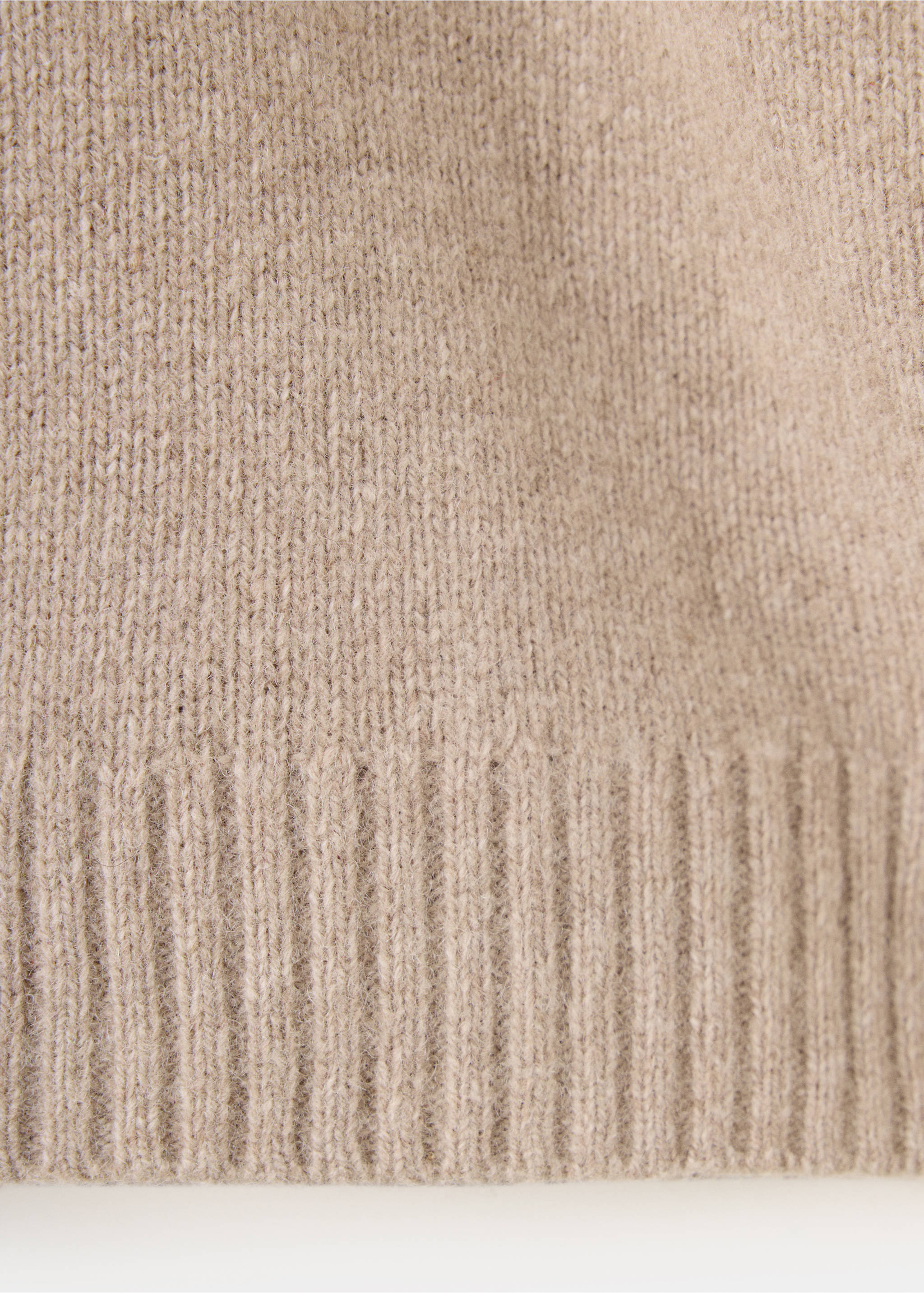 Close-up of a beige children's knitted sweater showing the ribbed hem., Medium Brown. Ref: 37039227-00.