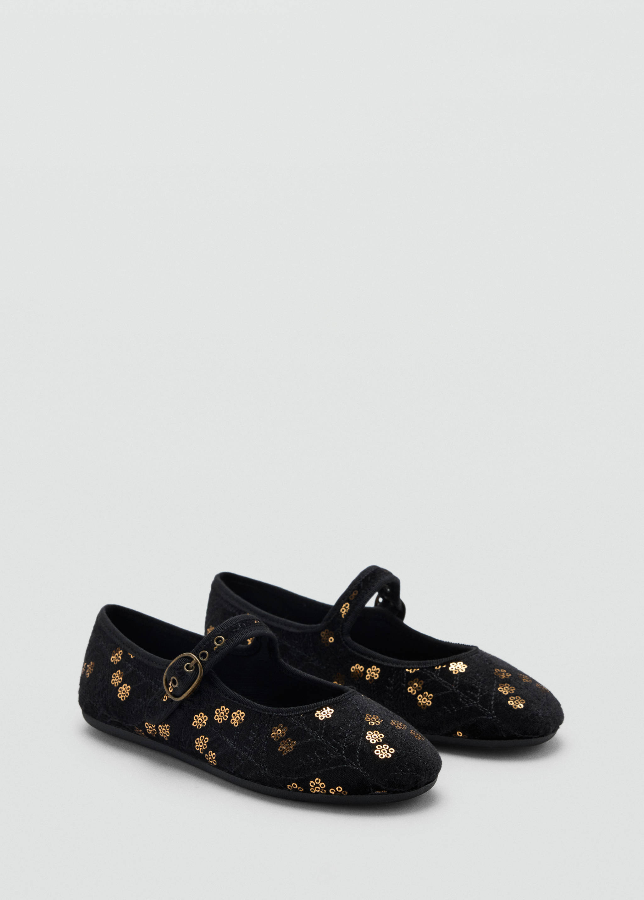 Black children's Mary Jane shoes with gold floral motifs and buckle straps.