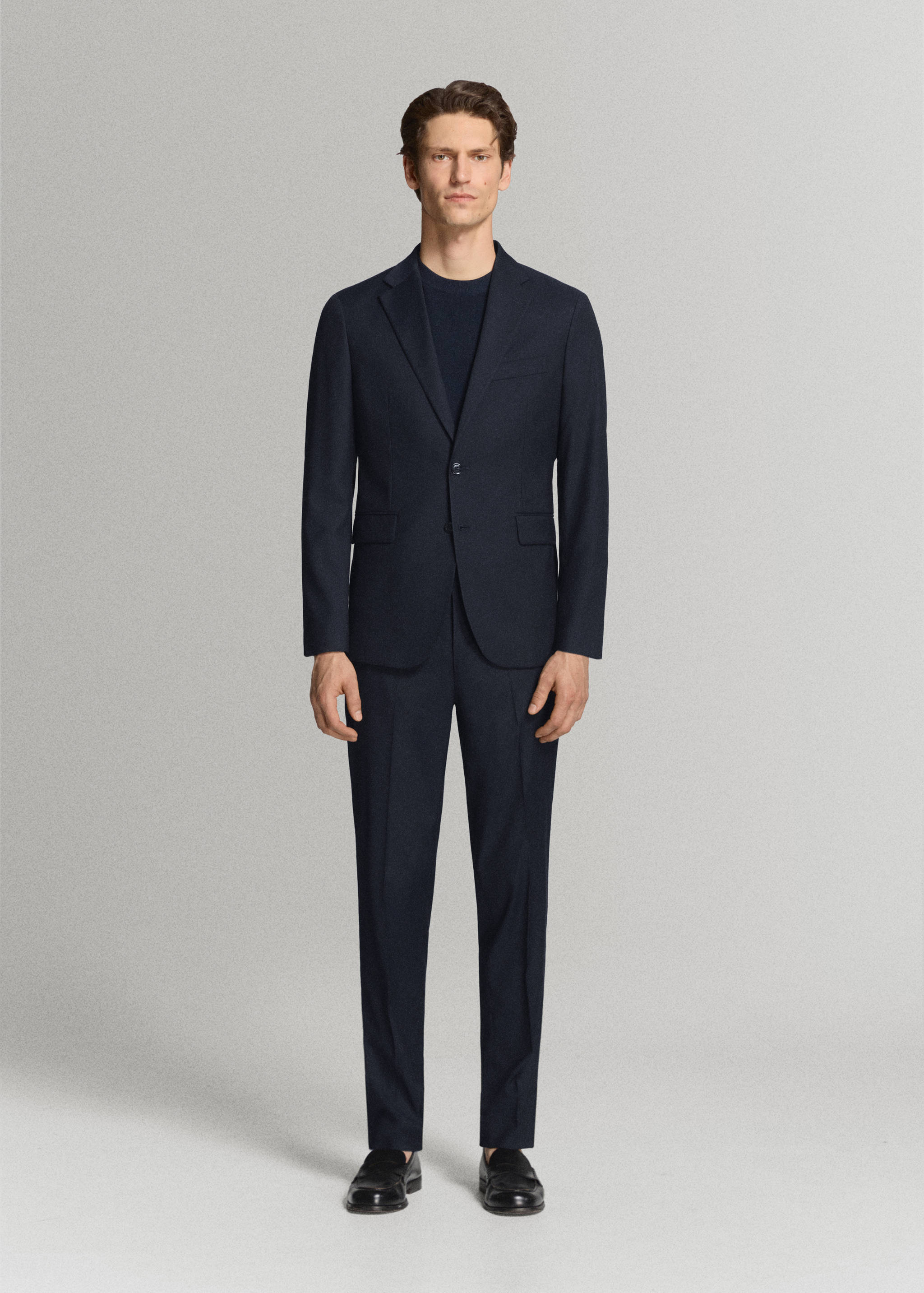 Navy blue trousers worn with a matching blazer and dark jumper