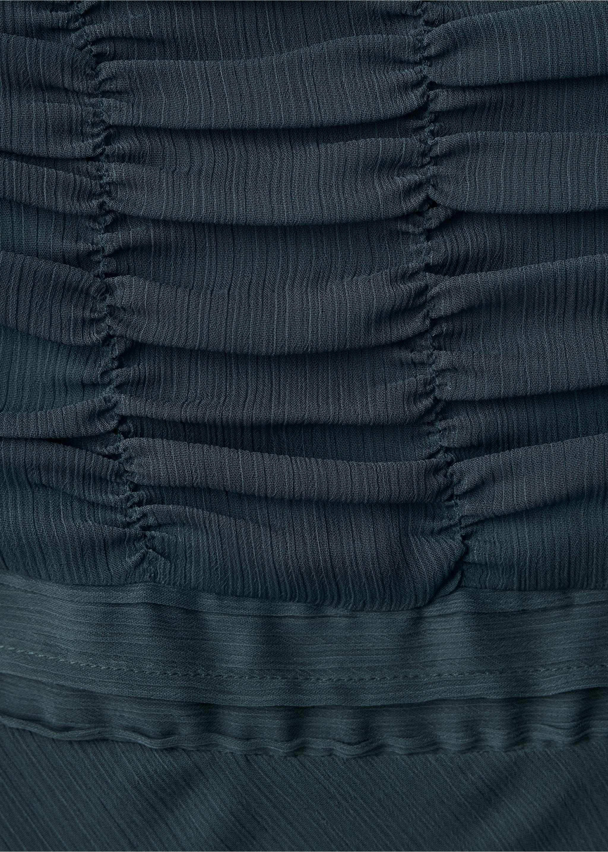 Close-up of the dark teal dress featuring pleated fabric and horizontal ruching., Charcoal. Ref: 37041552-00.