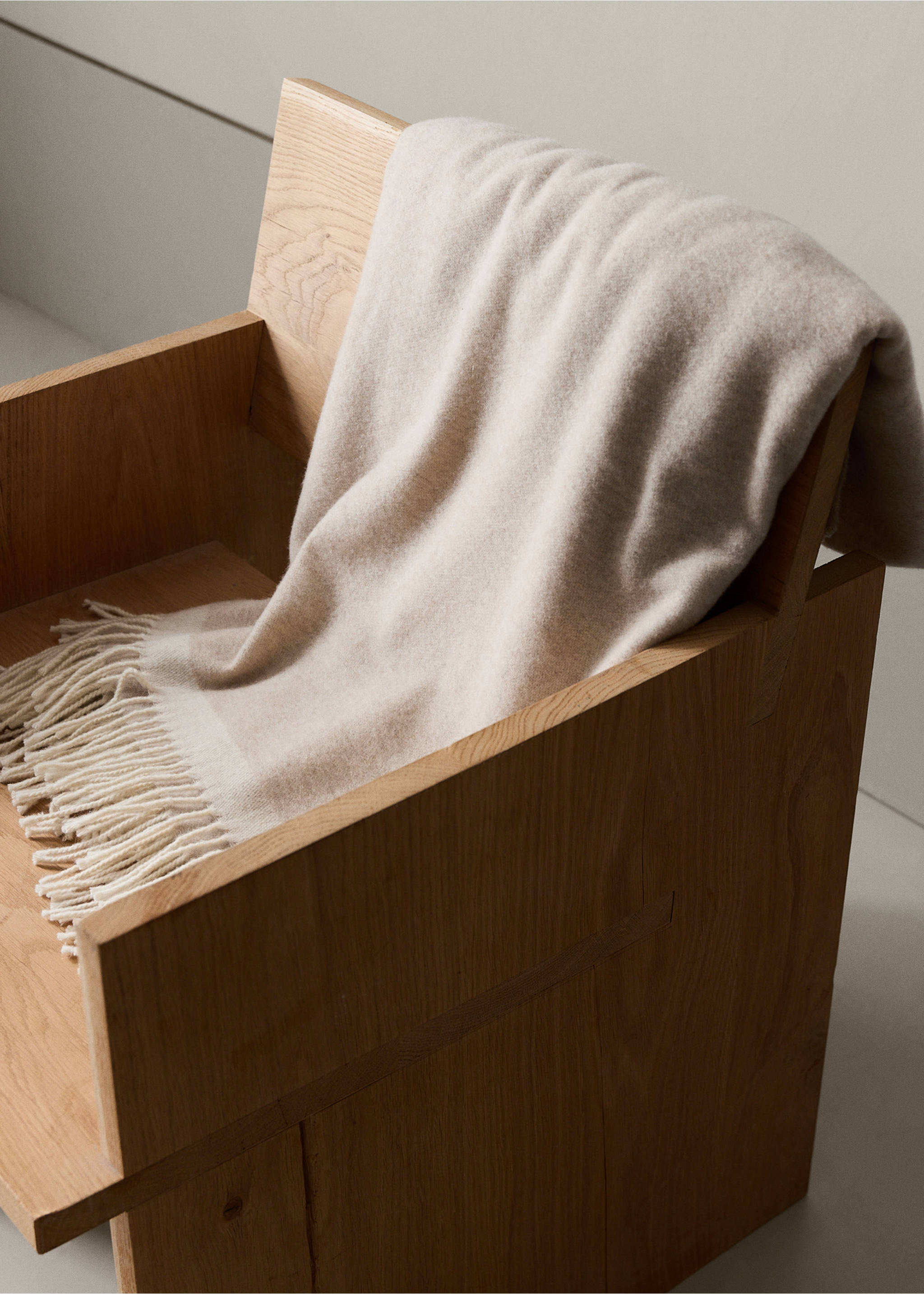 Light beige blanket with fringe draped over a wooden armchair., Beige. Ref: 37042554-00.