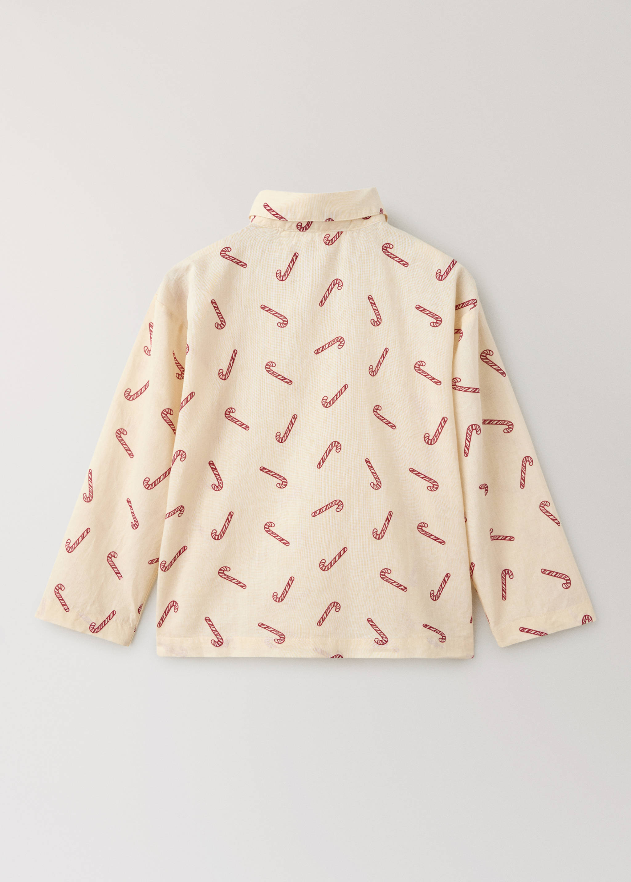Cream pyjama shirt with a red candy cane print, shown from the back.