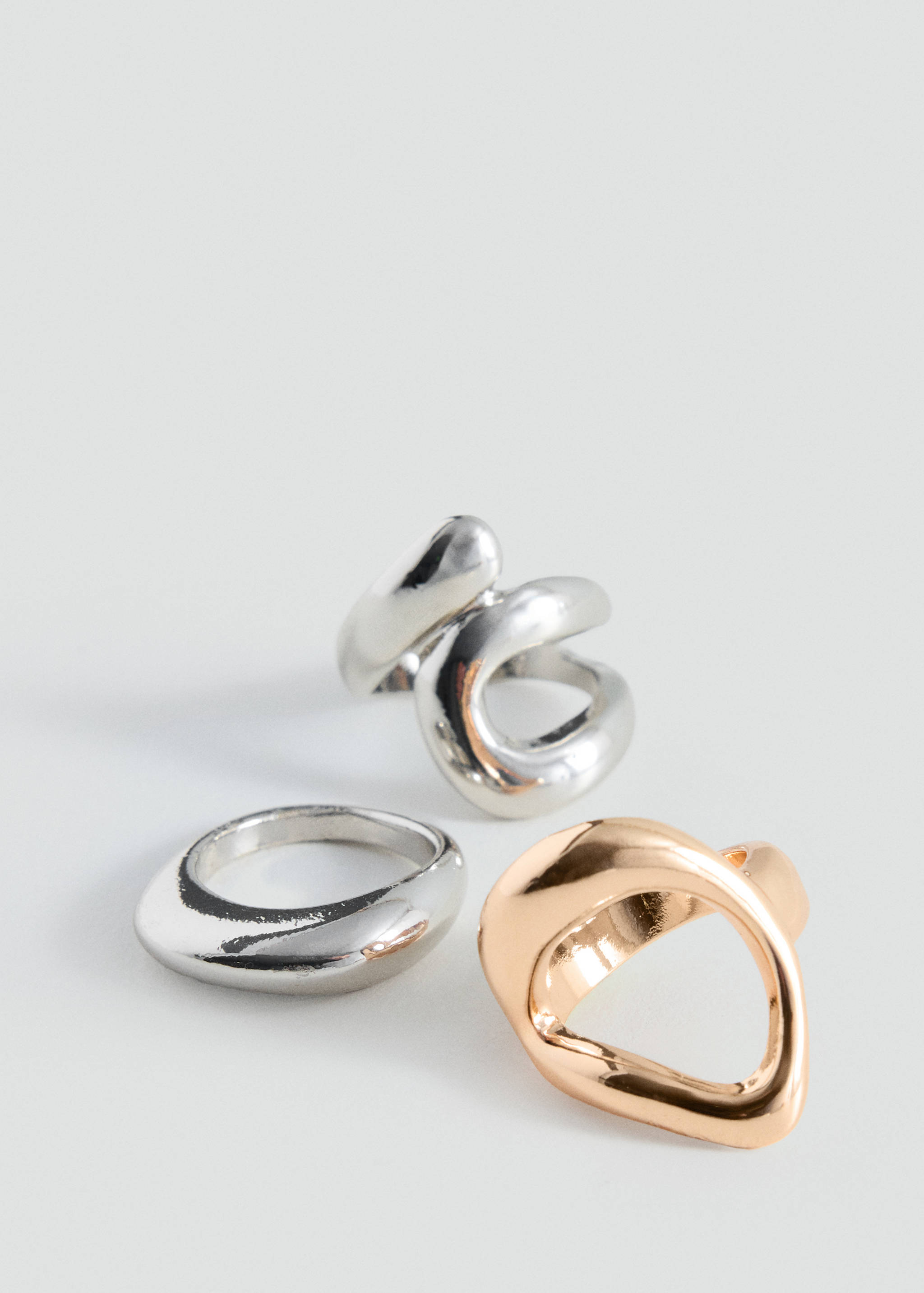 Set of three metallic rings in gold and silver tones.