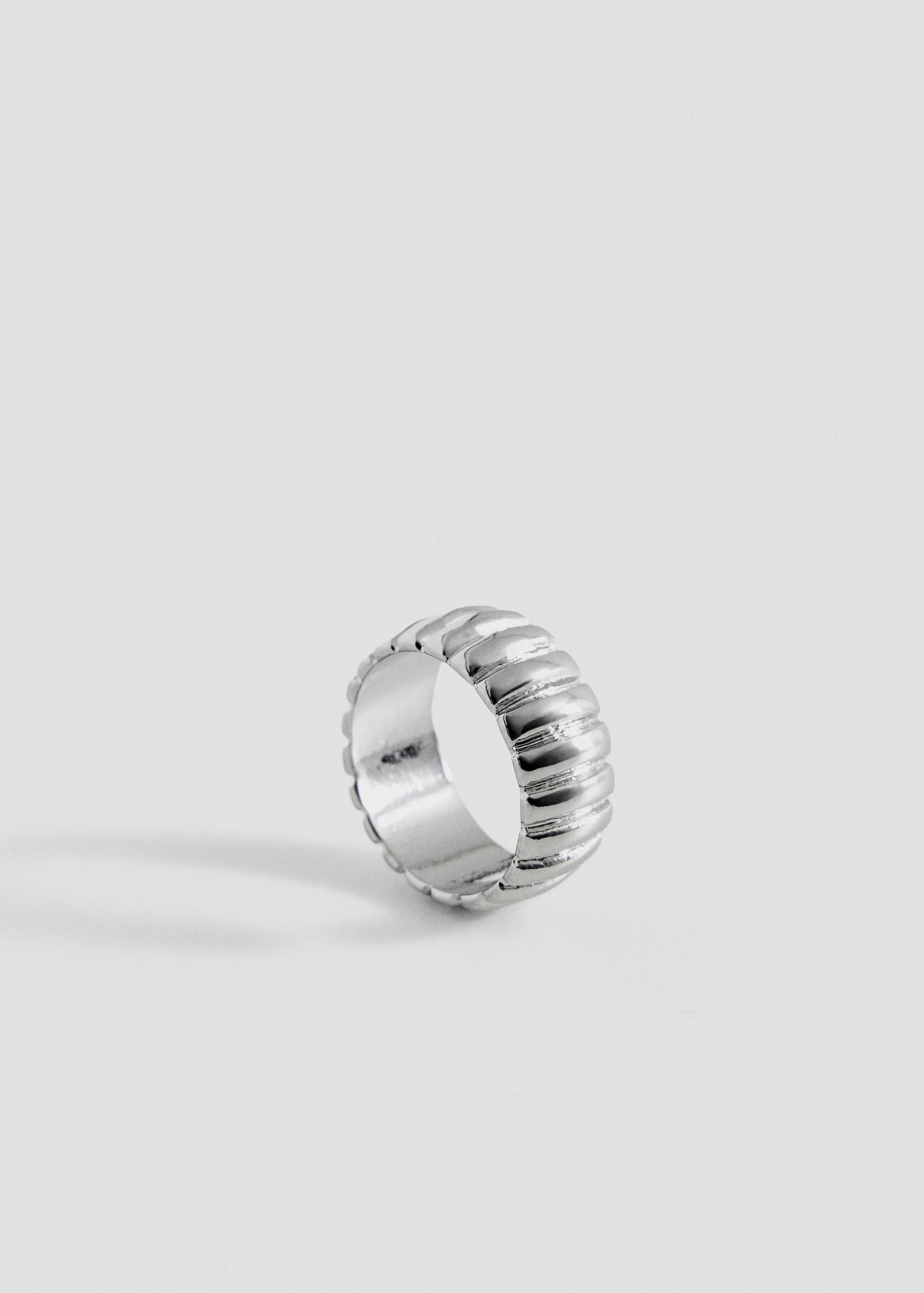 Silver-toned ring with a textured ribbed band.