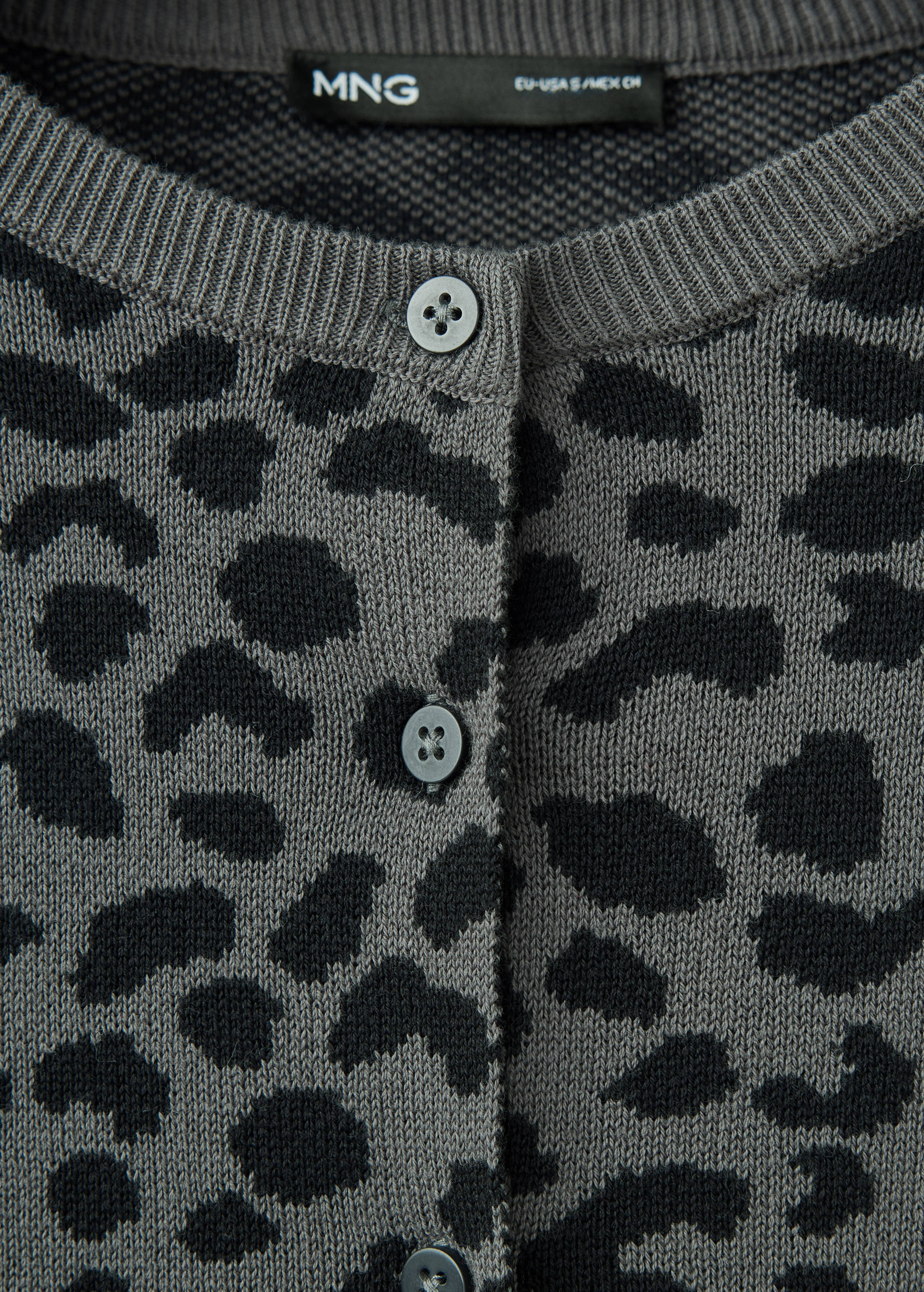 Close-up of a grey animal-print cardigan with a round neck and buttons.