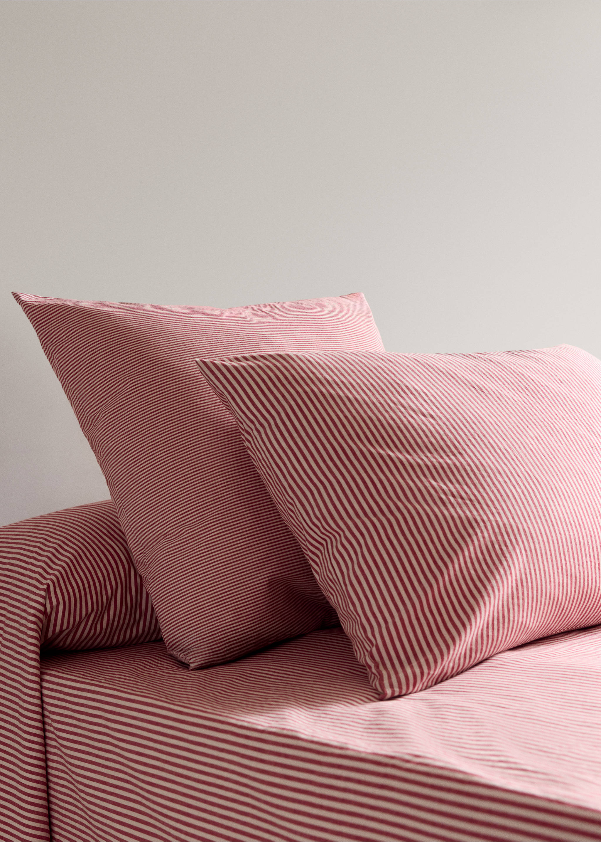 Red and white striped pillowcases on a matching bed., Red. Ref: 37046332-00.