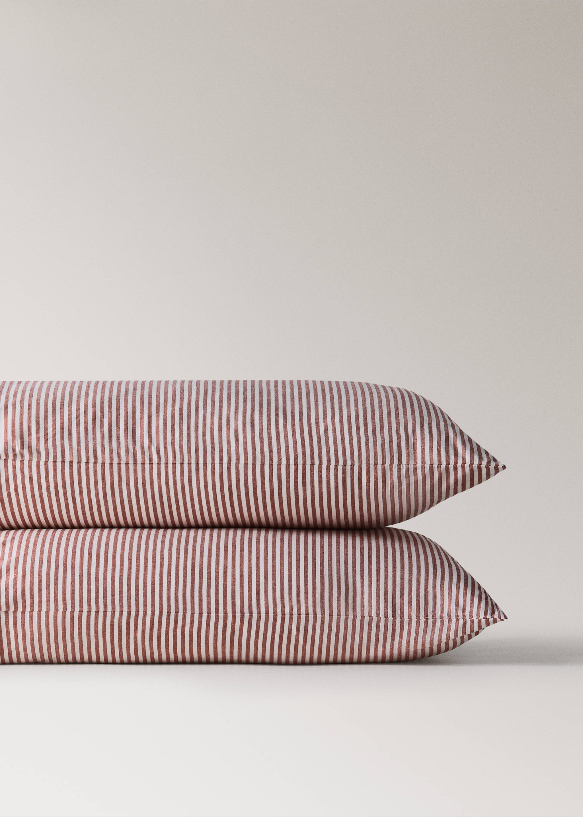 Reddish-brown and white striped pillowcases in a stacked view., Red. Ref: 37046332-00.