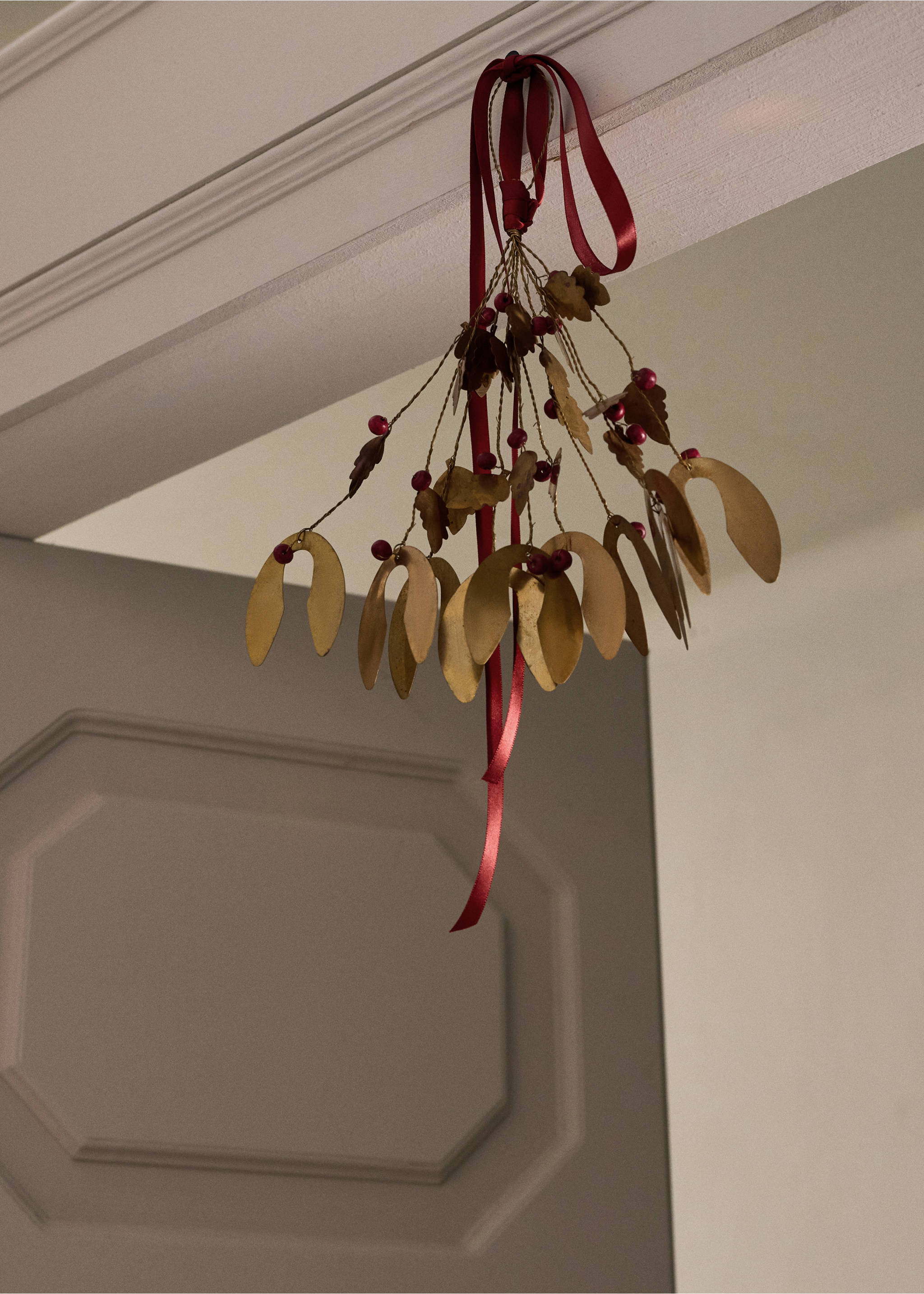 Gold-toned metallic mistletoe hanging ornament with red berries and a red satin ribbon., Gold. Ref: 37046736-00.
