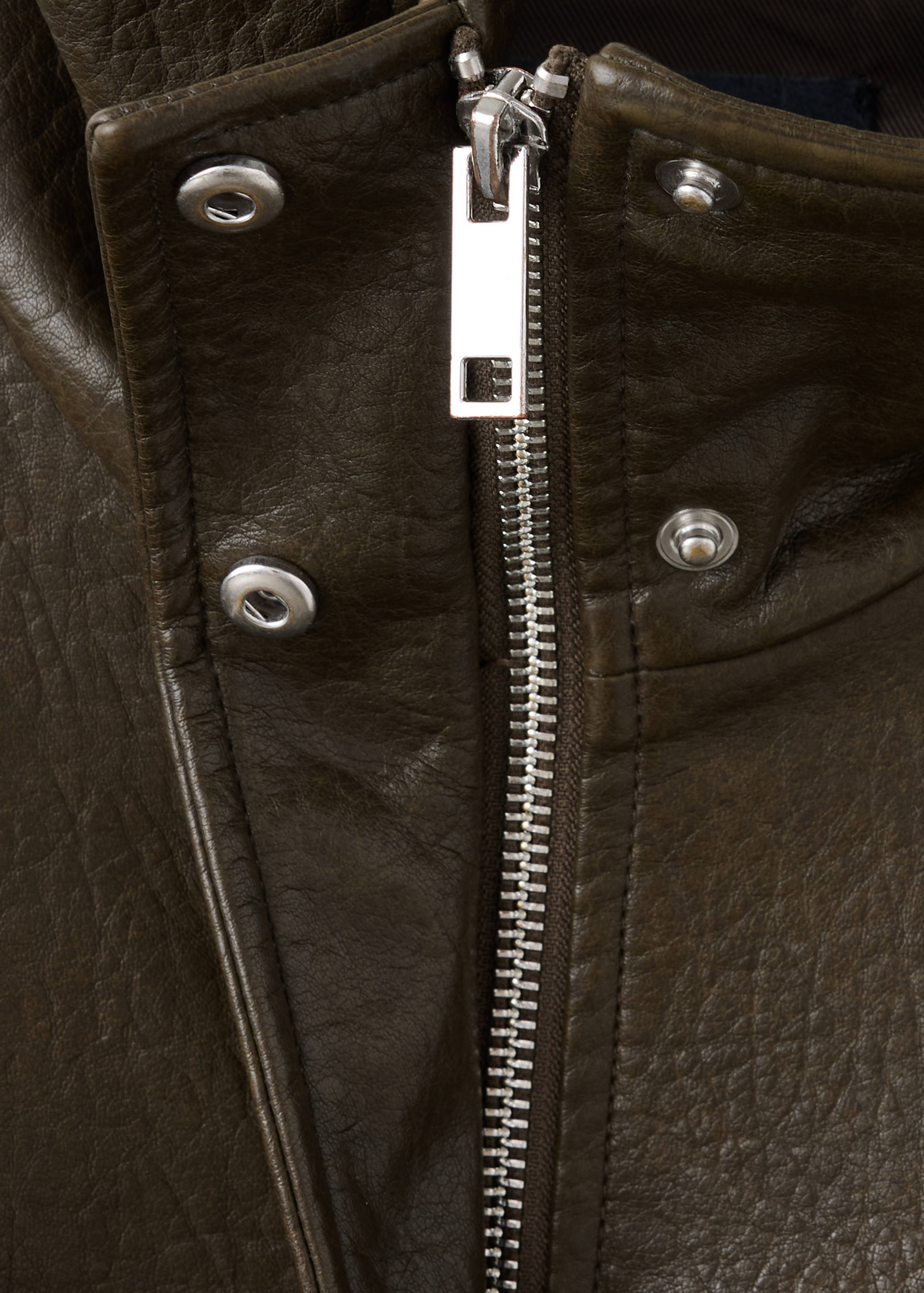 Close-up of an olive green leather jacket collar and zipper detail.