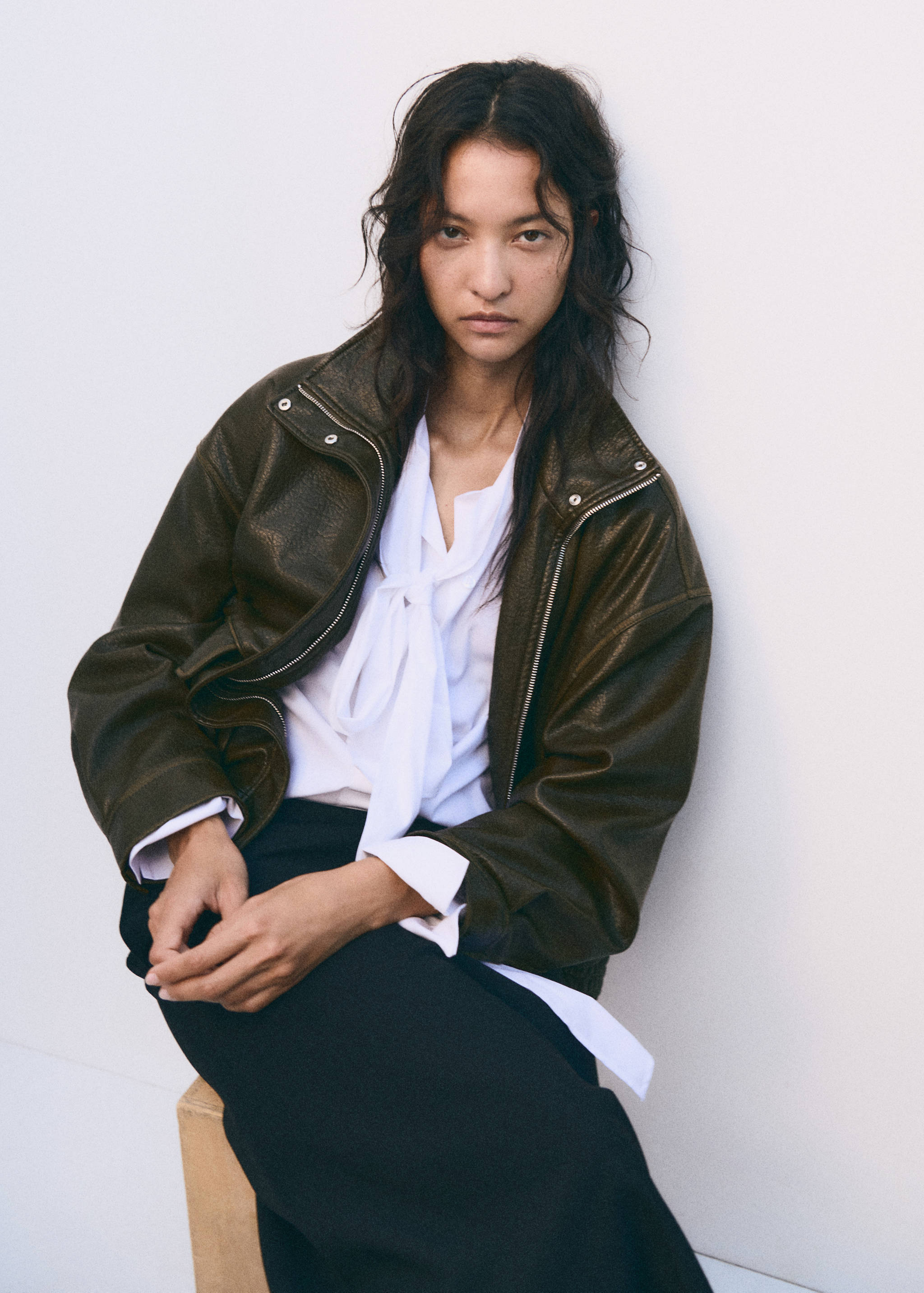 Dark olive-green faux-leather jacket in an oversized fit with a high collar and front zip.
