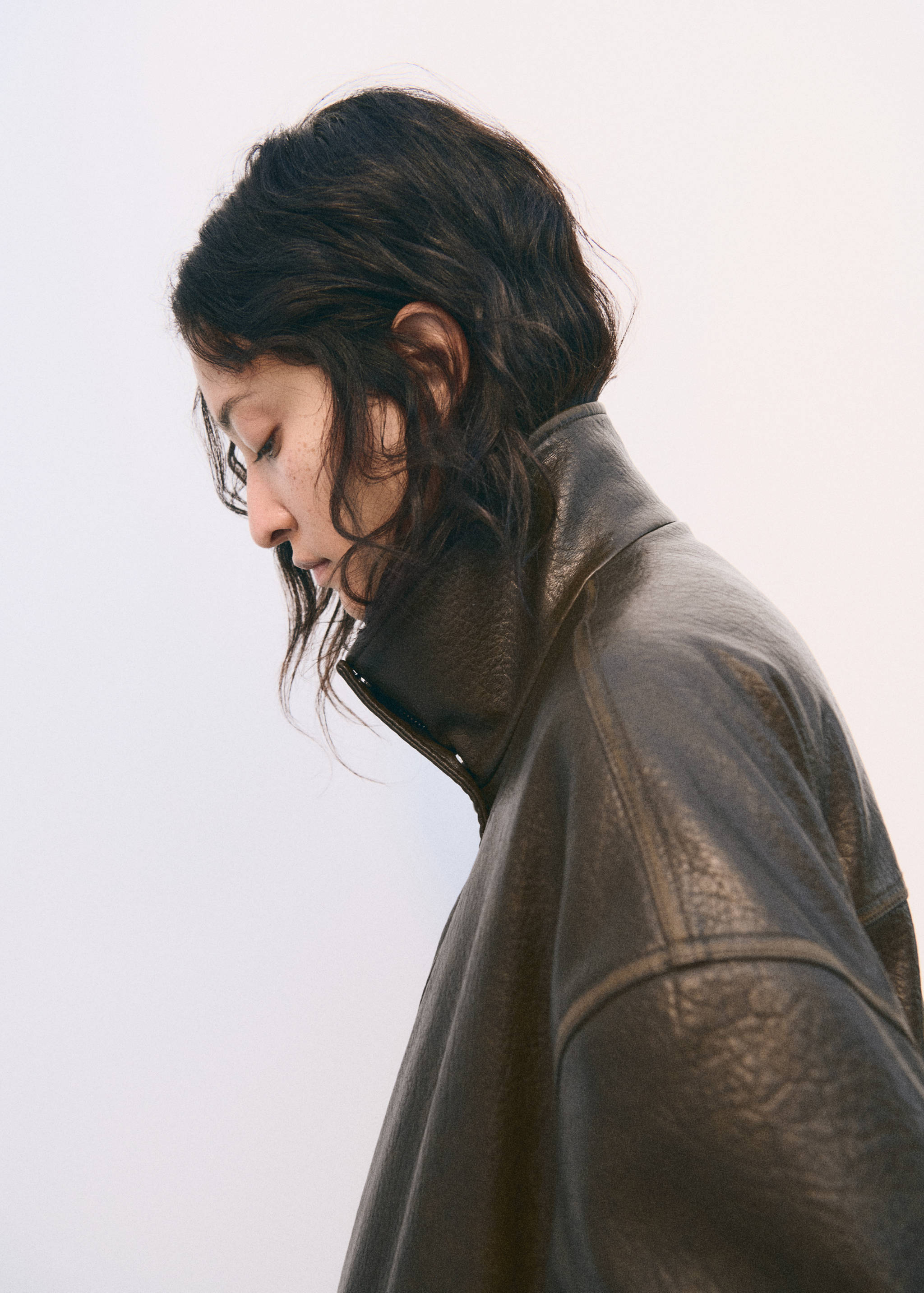 Close-up of a dark brown jacket with a high collar.