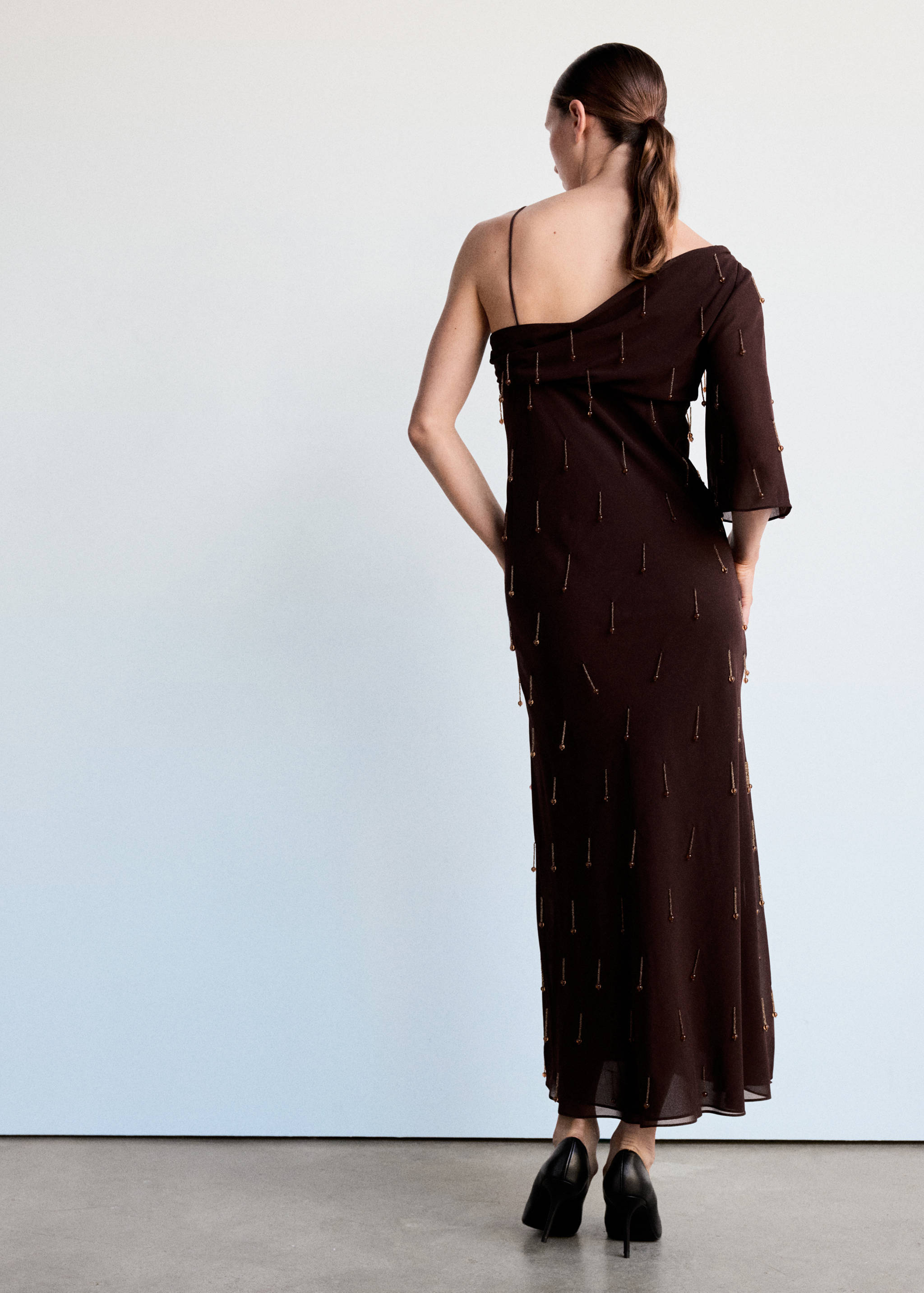 Asymmetric dress with fringes and embellishments - Reverse of the article