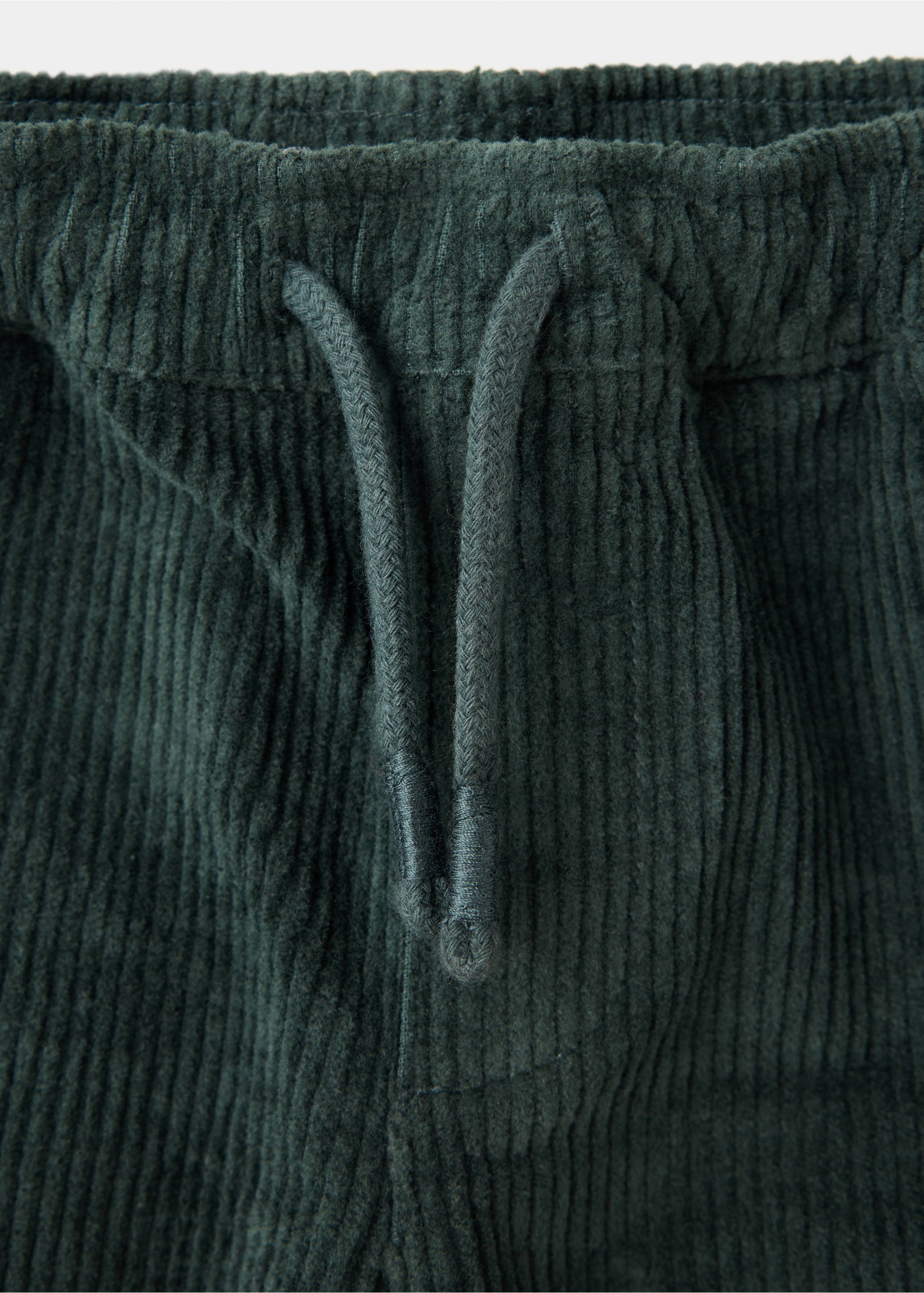 Dark green corduroy trousers detail showing the elasticated drawstring waistband., Petrol Blue. Ref: 37047125-00.