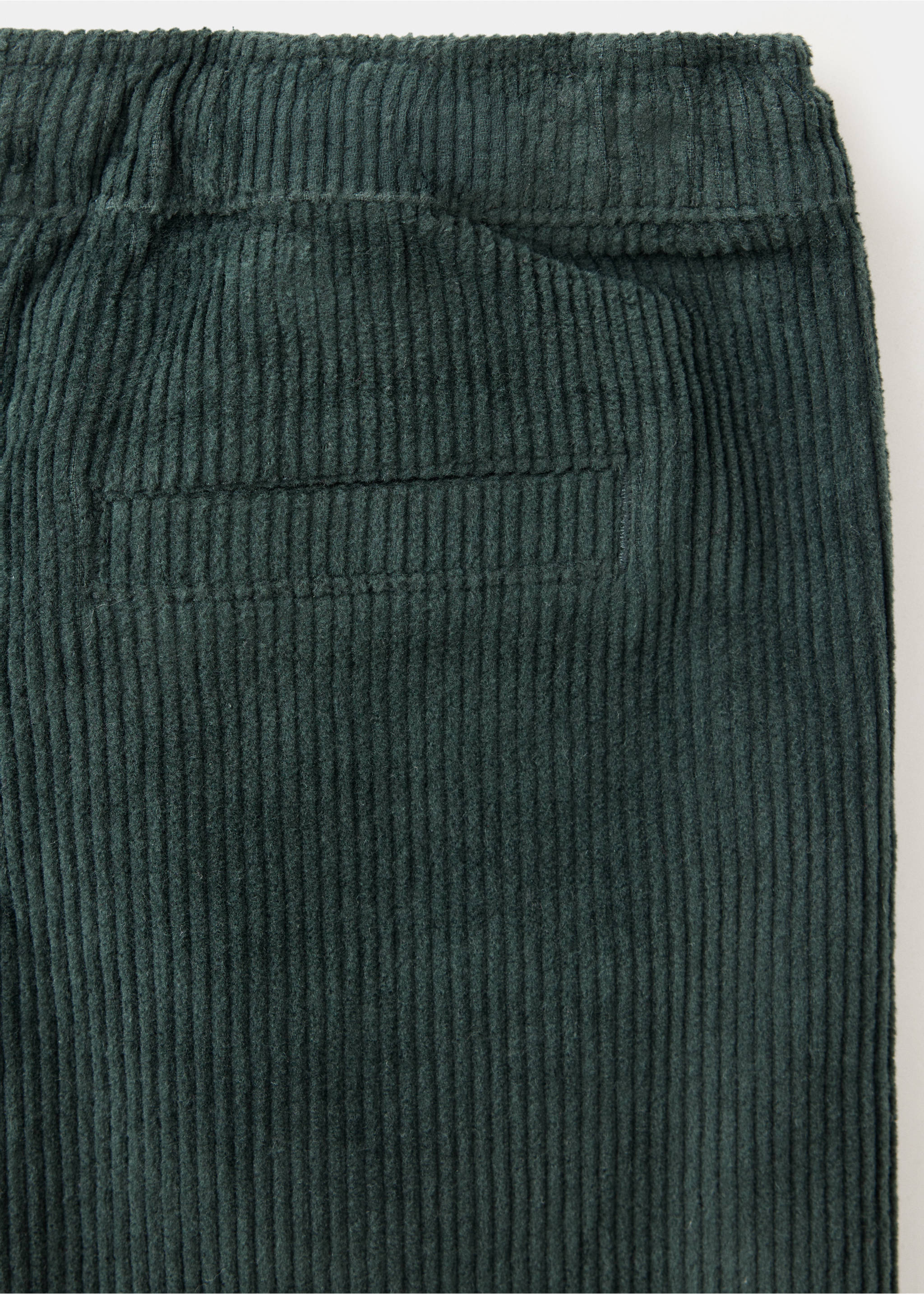 Dark green corduroy trousers fabric detail showing vertical ribs and a back pocket., Petrol Blue. Ref: 37047125-00.
