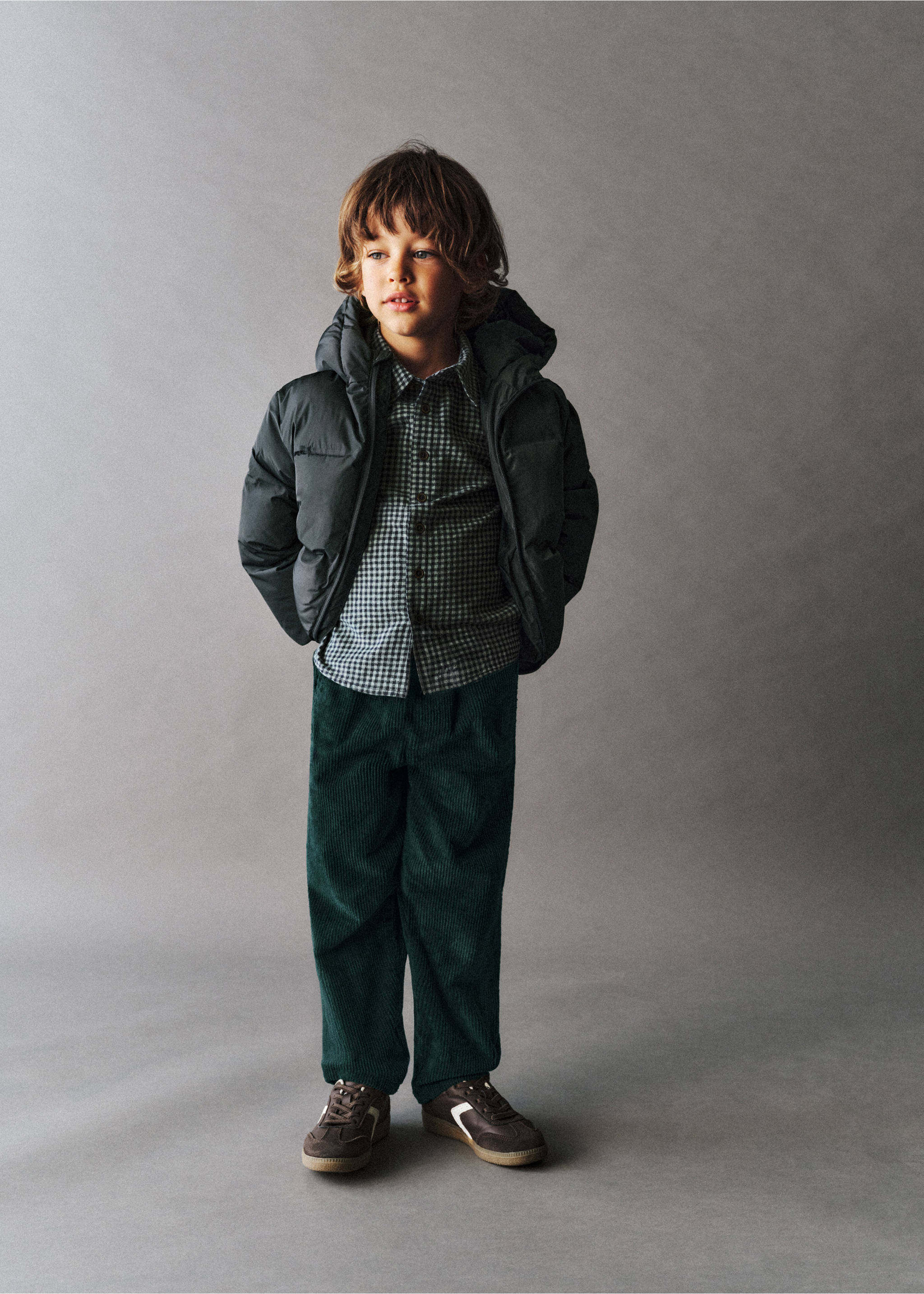 Dark green corduroy trousers with a relaxed fit, worn with a puffer jacket and checked shirt., Petrol Blue. Ref: 37047125-00.