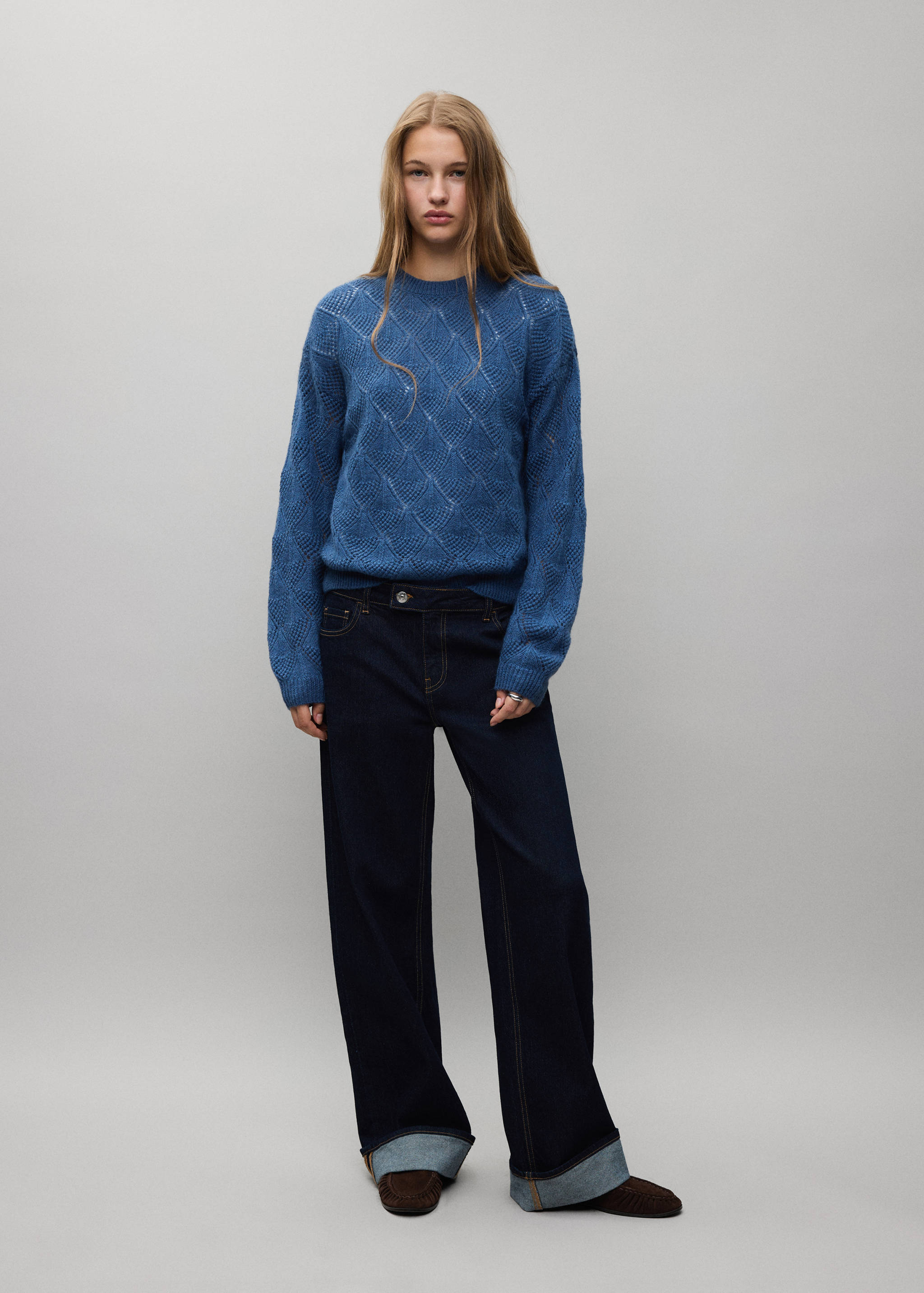 Blue knitted openwork jersey with a round neckline and long sleeves.