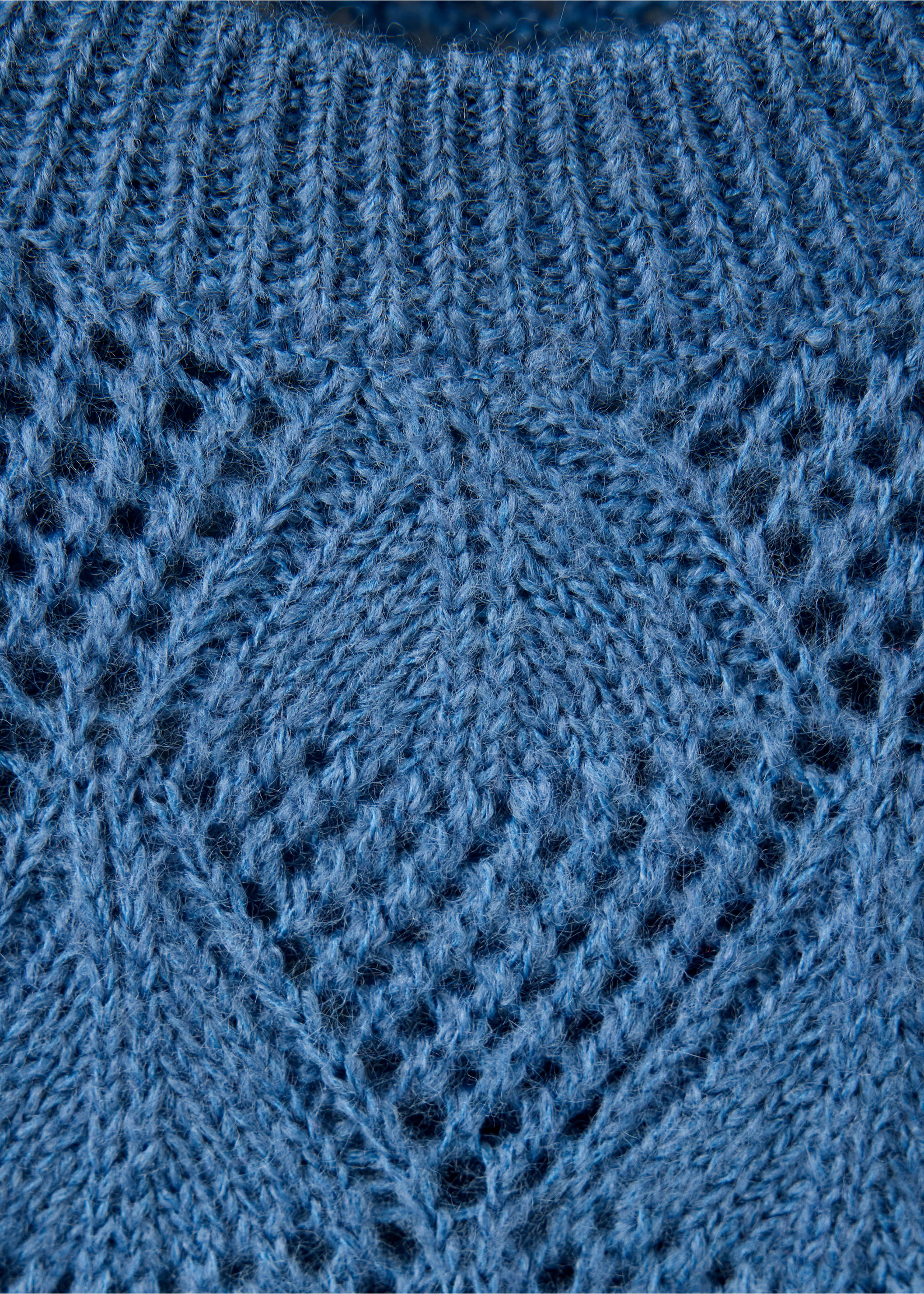 Blue knit jersey sweater close-up showing a ribbed neckline and openwork pattern., Blue. Ref: 37047136-00.