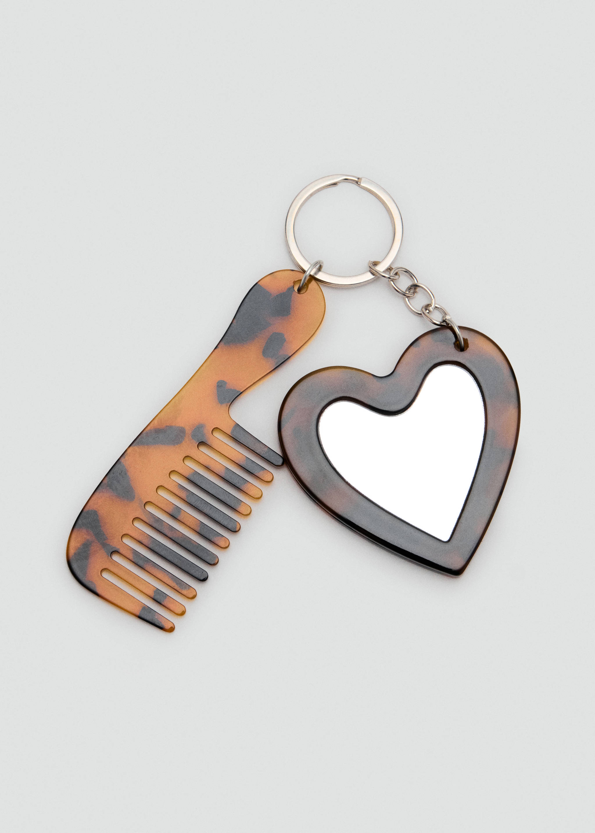 Tortoiseshell-patterned gadget keychain with comb and heart mirror.