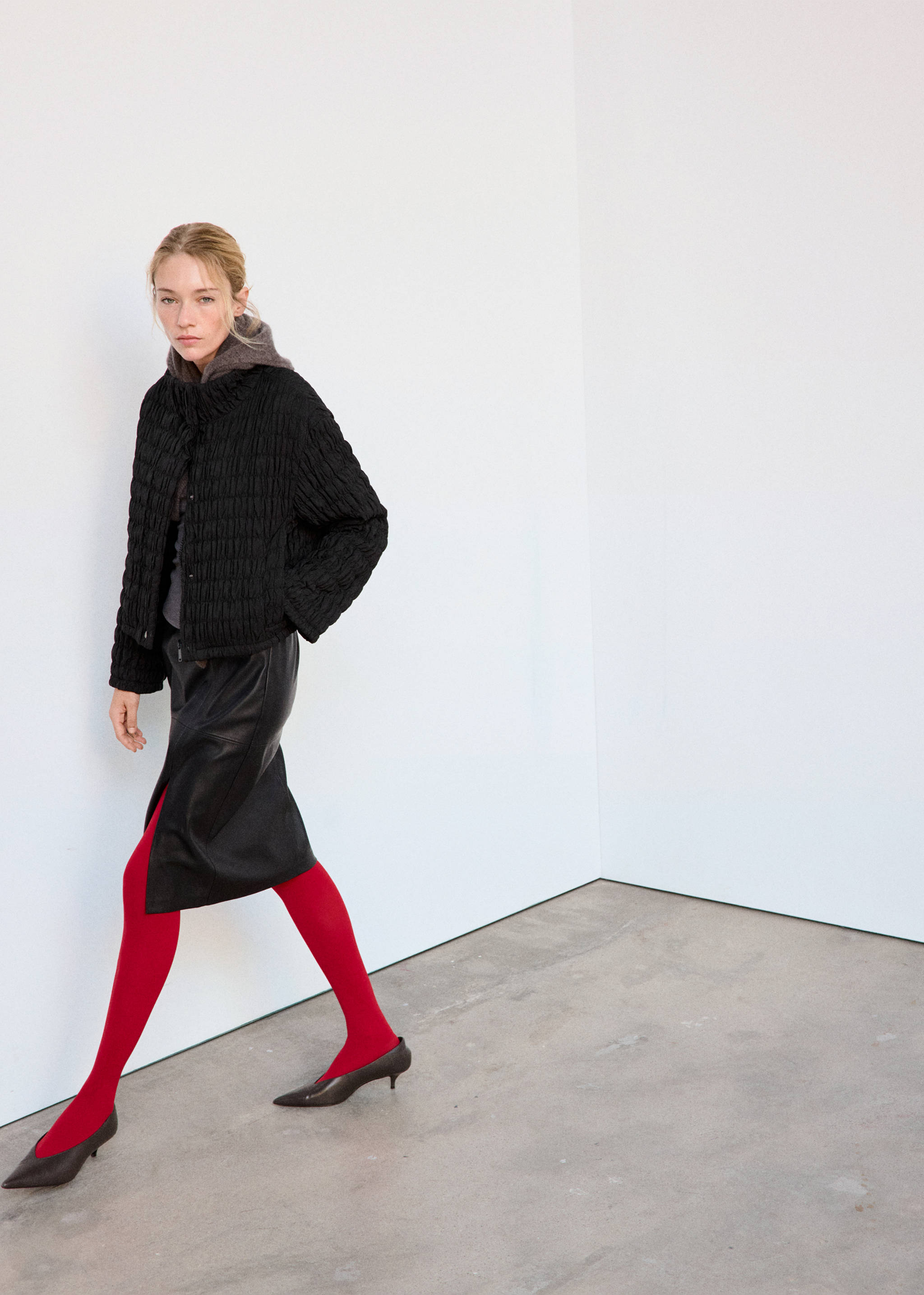 Black quilted anorak with a stand collar and vertical texture.