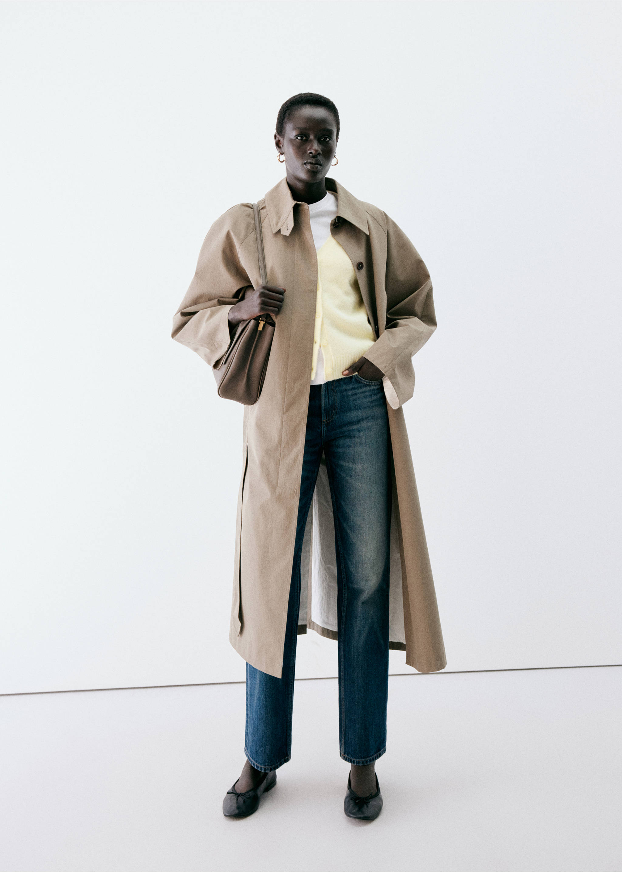 Pale yellow cardigan layered under an open beige trench coat with blue jeans., Pastel Yellow. Ref: 37047774-00.