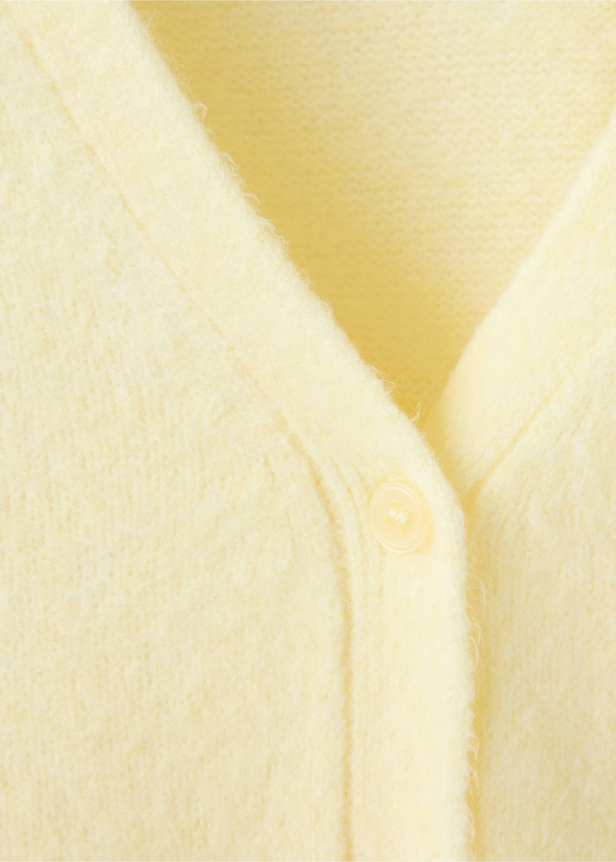 Close-up of a pale yellow cardigan's V-neck and button detail., Pastel Yellow. Ref: 37047774-00.