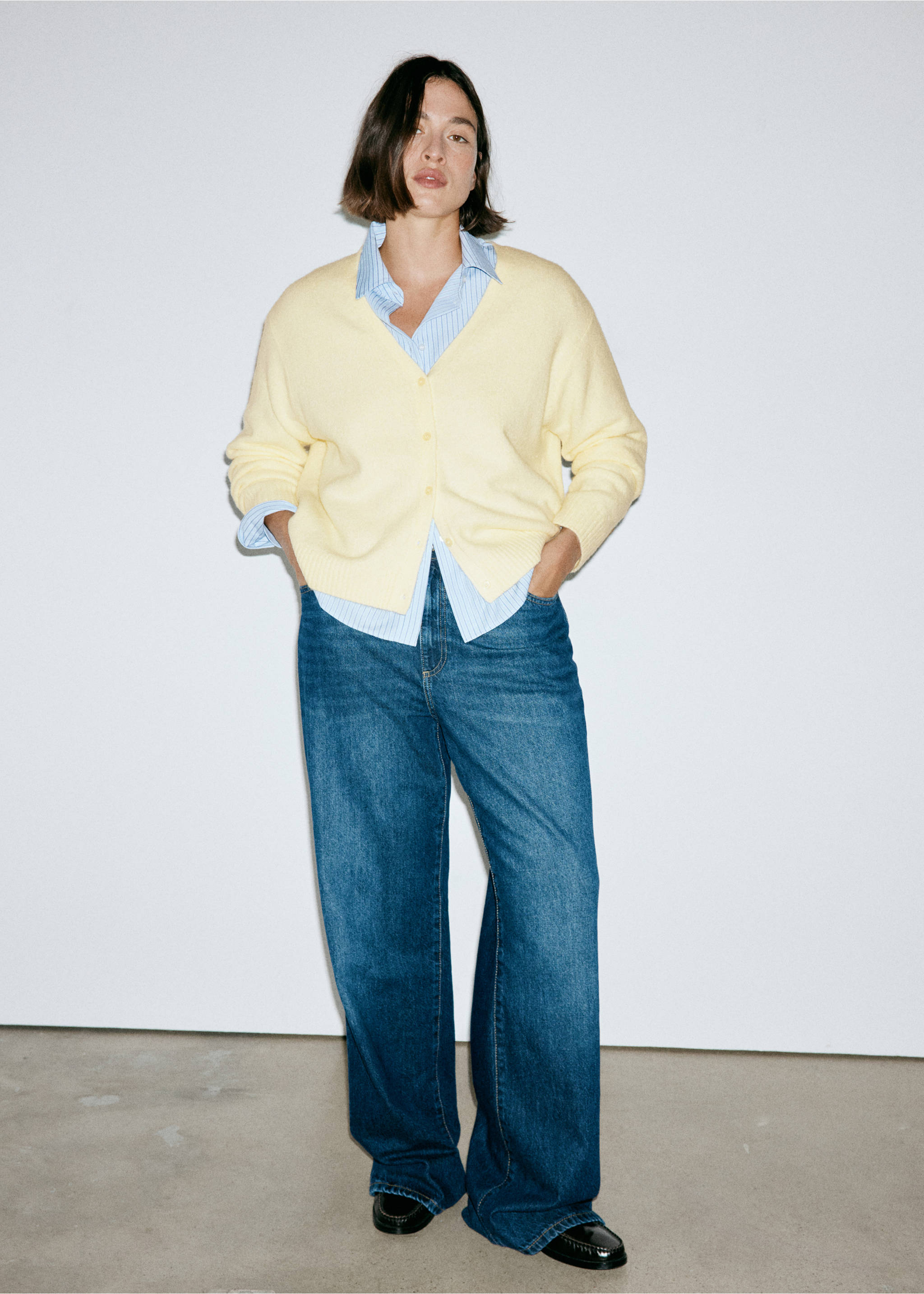 Light yellow V-neck cardigan worn with a striped shirt and blue trousers., Pastel Yellow. Ref: 37047774-00.