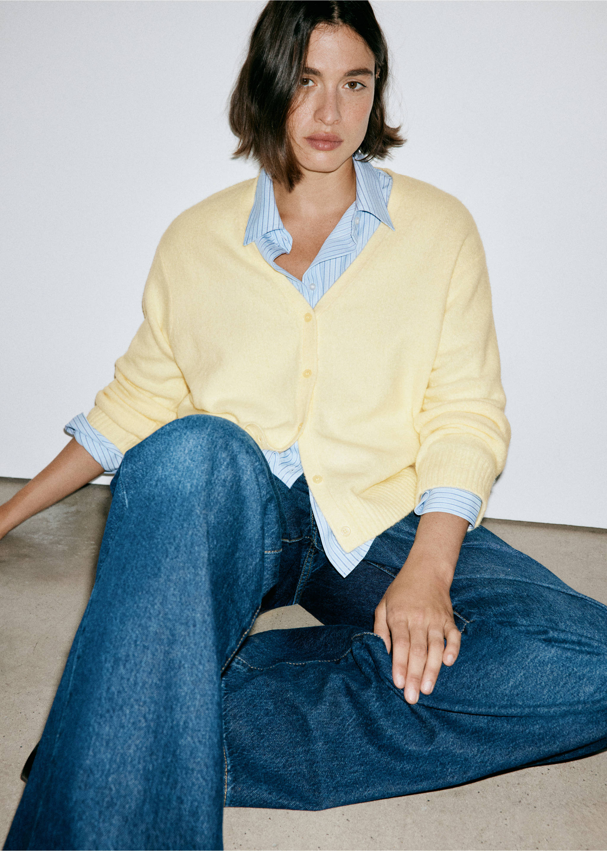 Pale yellow V-neck cardigan worn over a blue striped shirt., Pastel Yellow. Ref: 37047774-00.