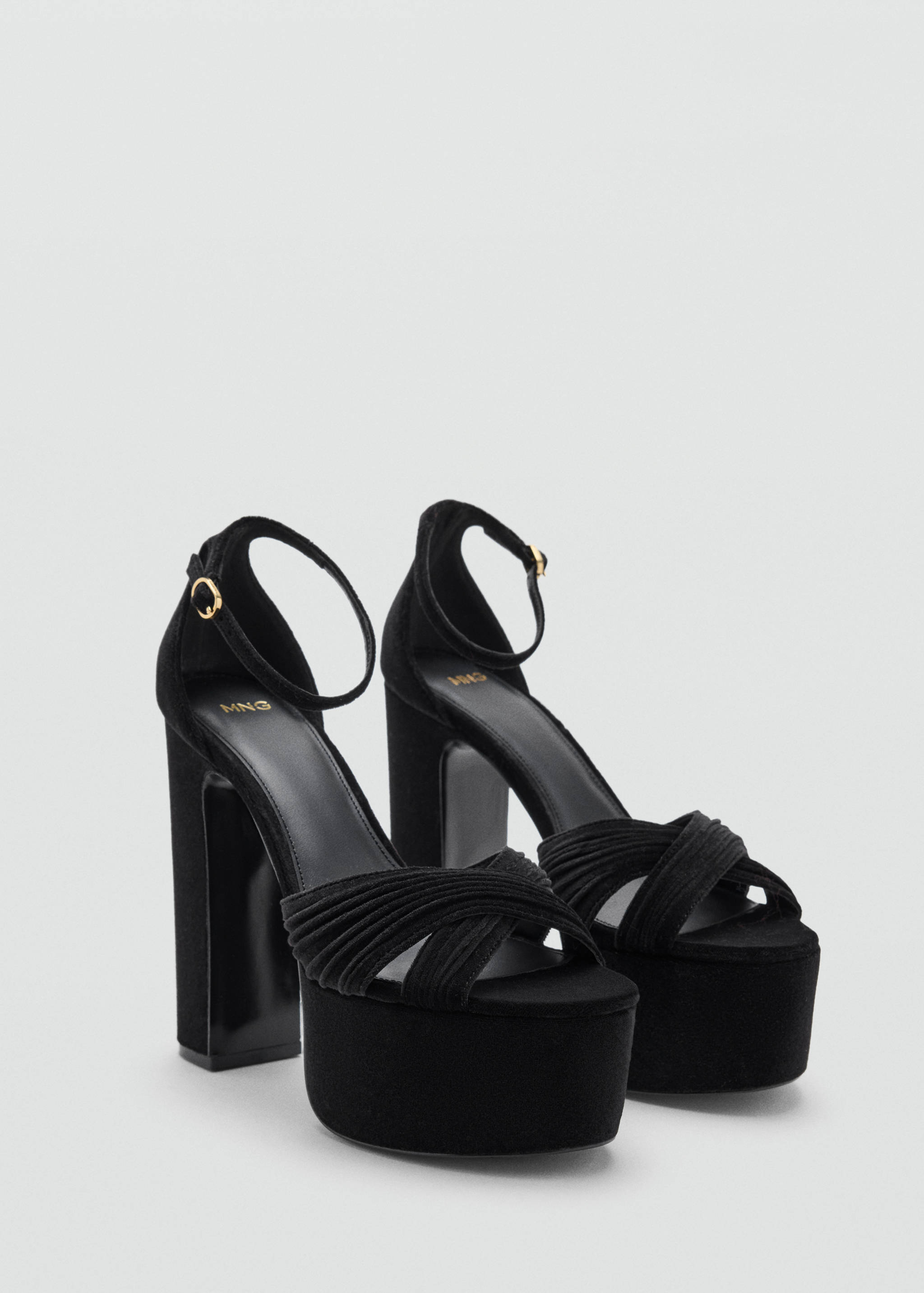 Black platform sandals with high block heels and criss-crossing straps.