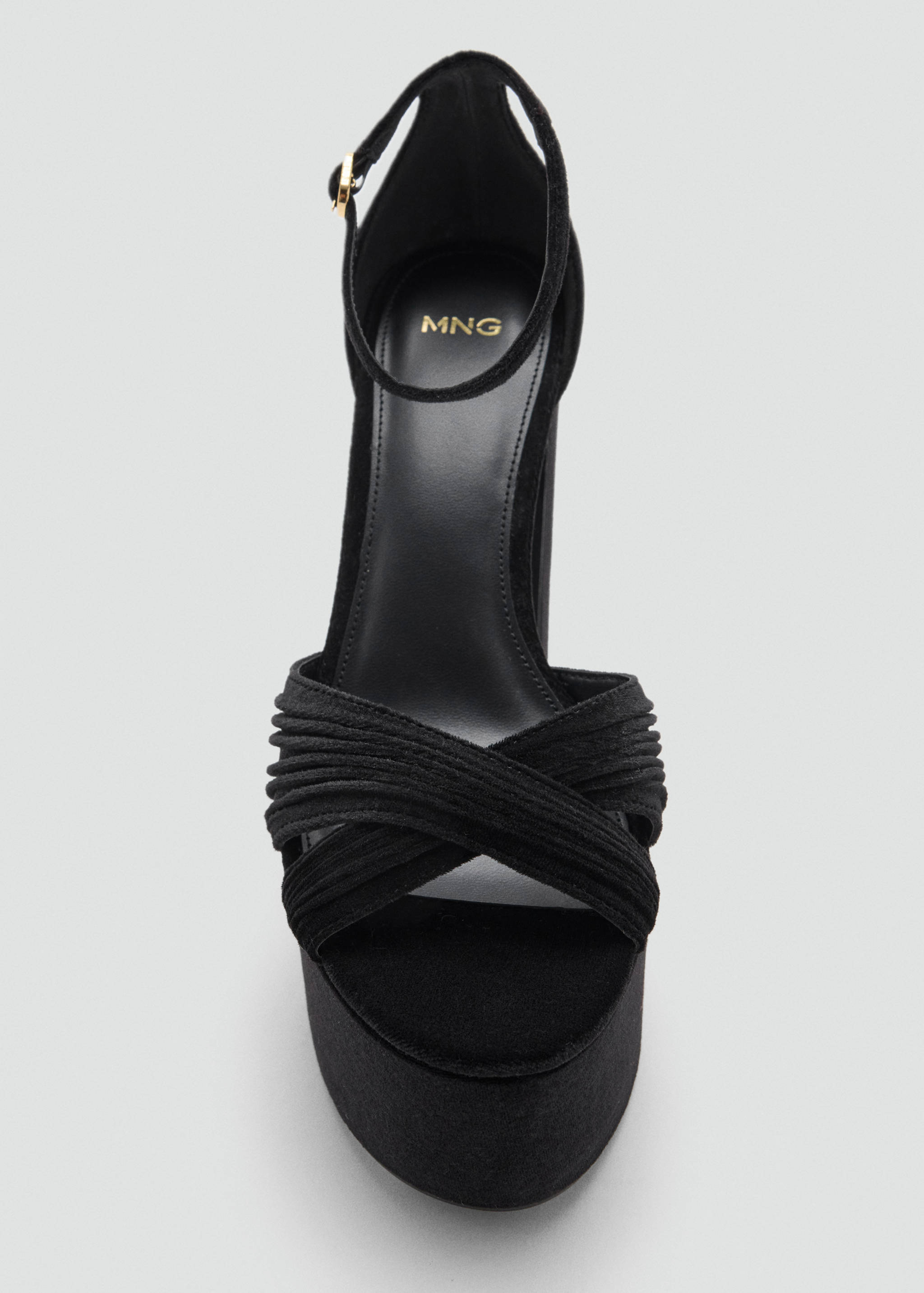 Black platform sandal with ruched crossover straps and ankle buckle.