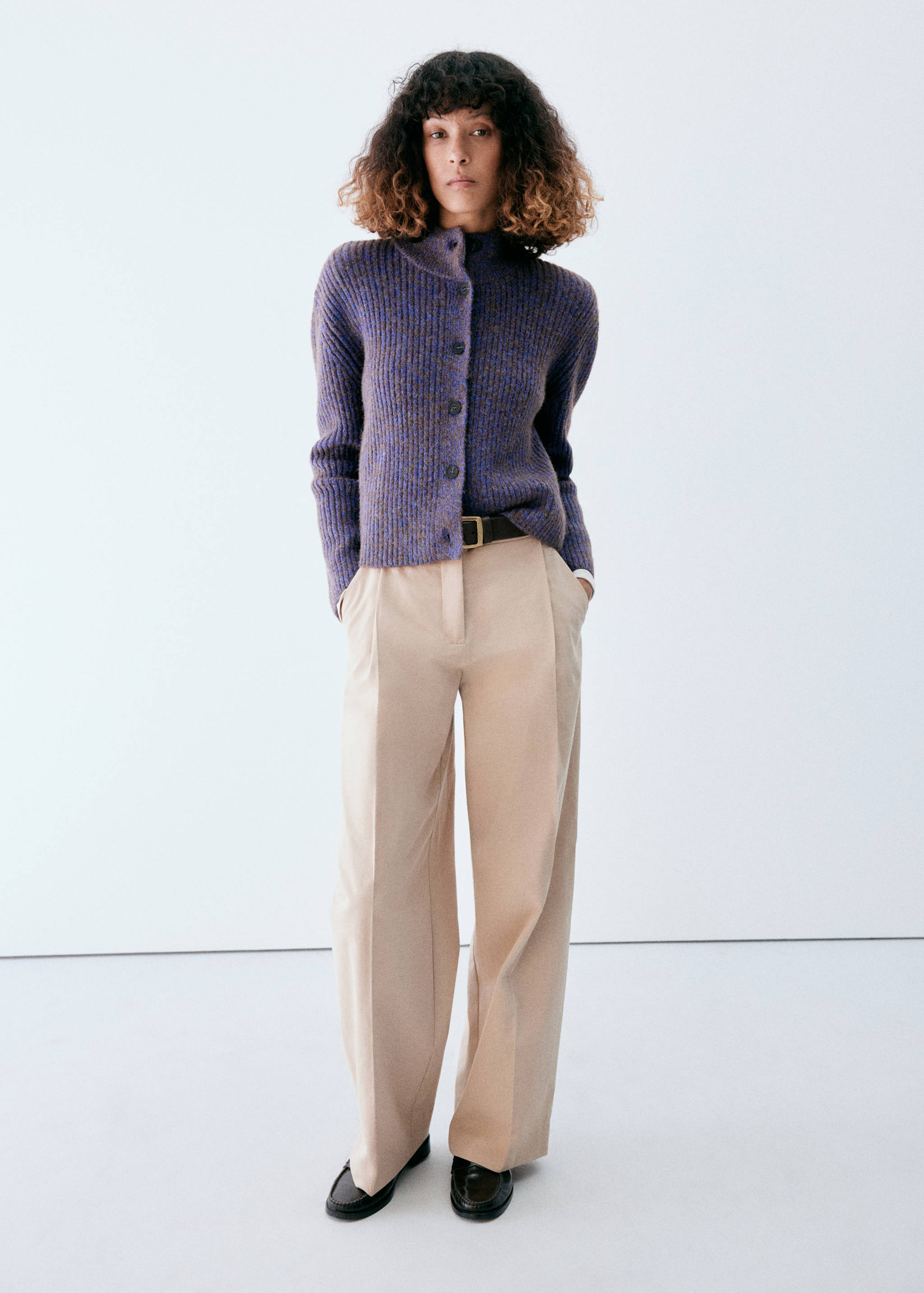 Purple ribbed knitted cardigan with a high collar and dark buttons.