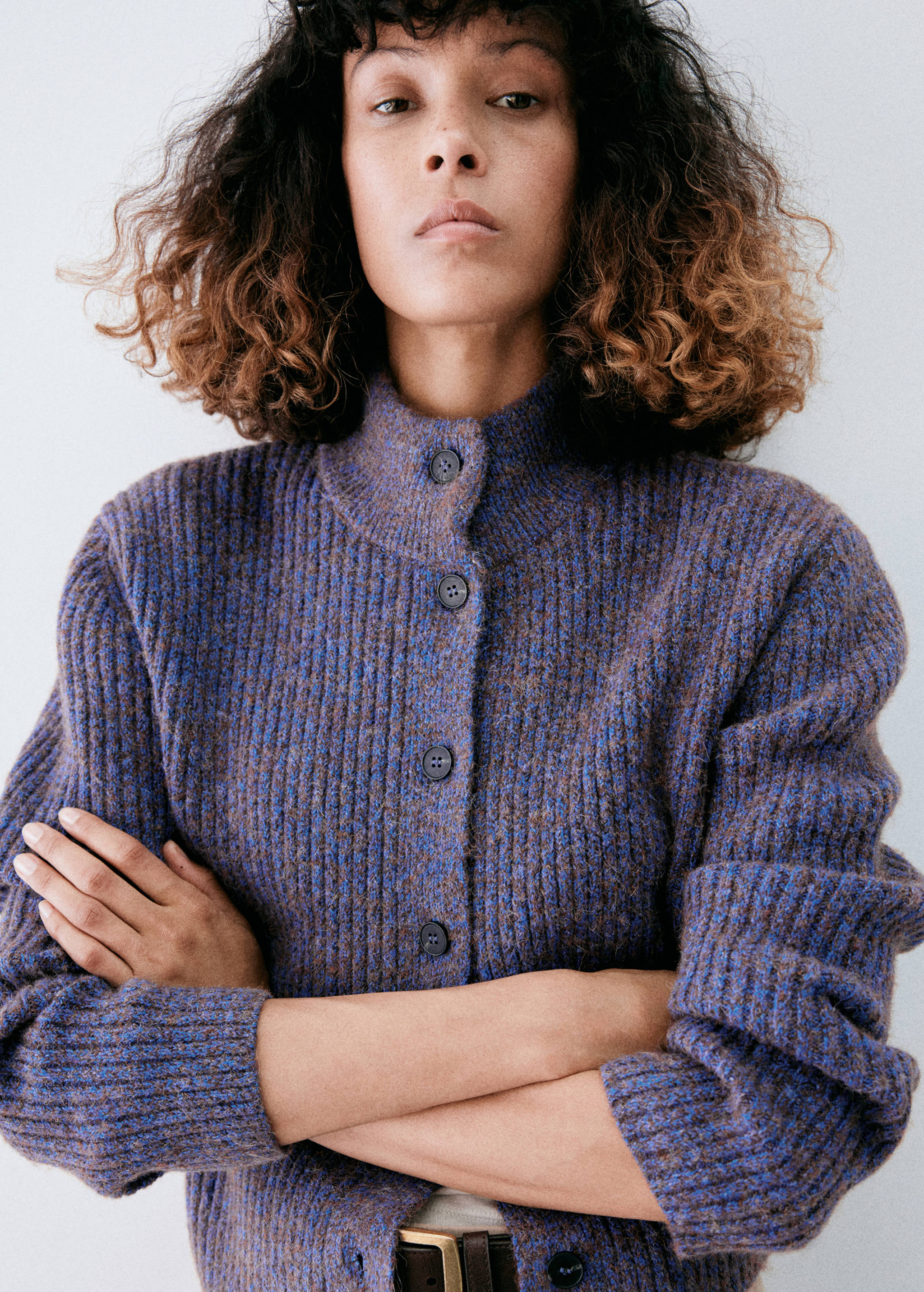 Blue and brown melange ribbed knit cardigan with stand collar and front buttons.