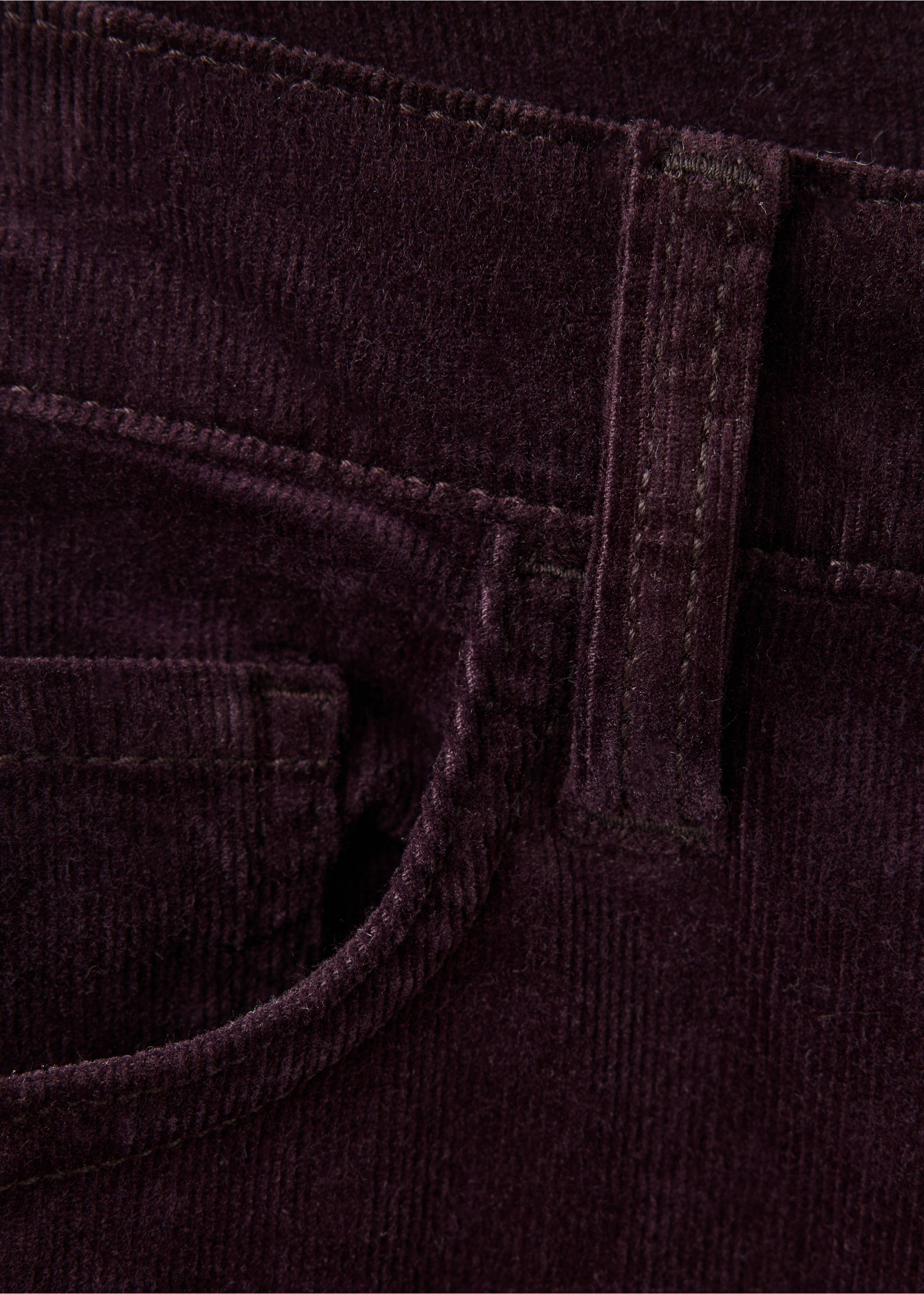 Close-up of dark purple corduroy trousers showing pocket and belt loop detail., Wine. Ref: 37047788-00.