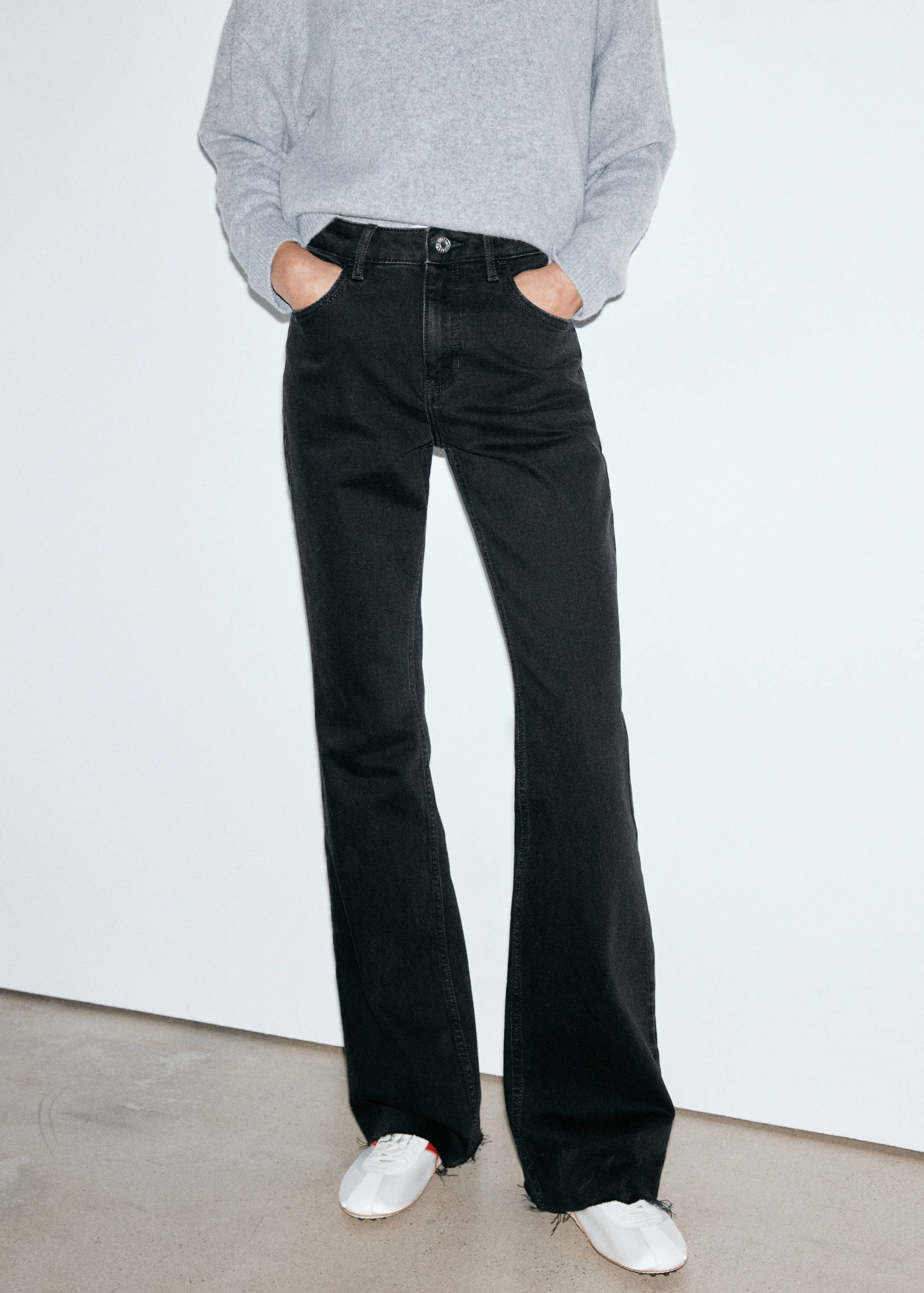 Dark grey straight-leg denim trousers styled with a grey sweater.