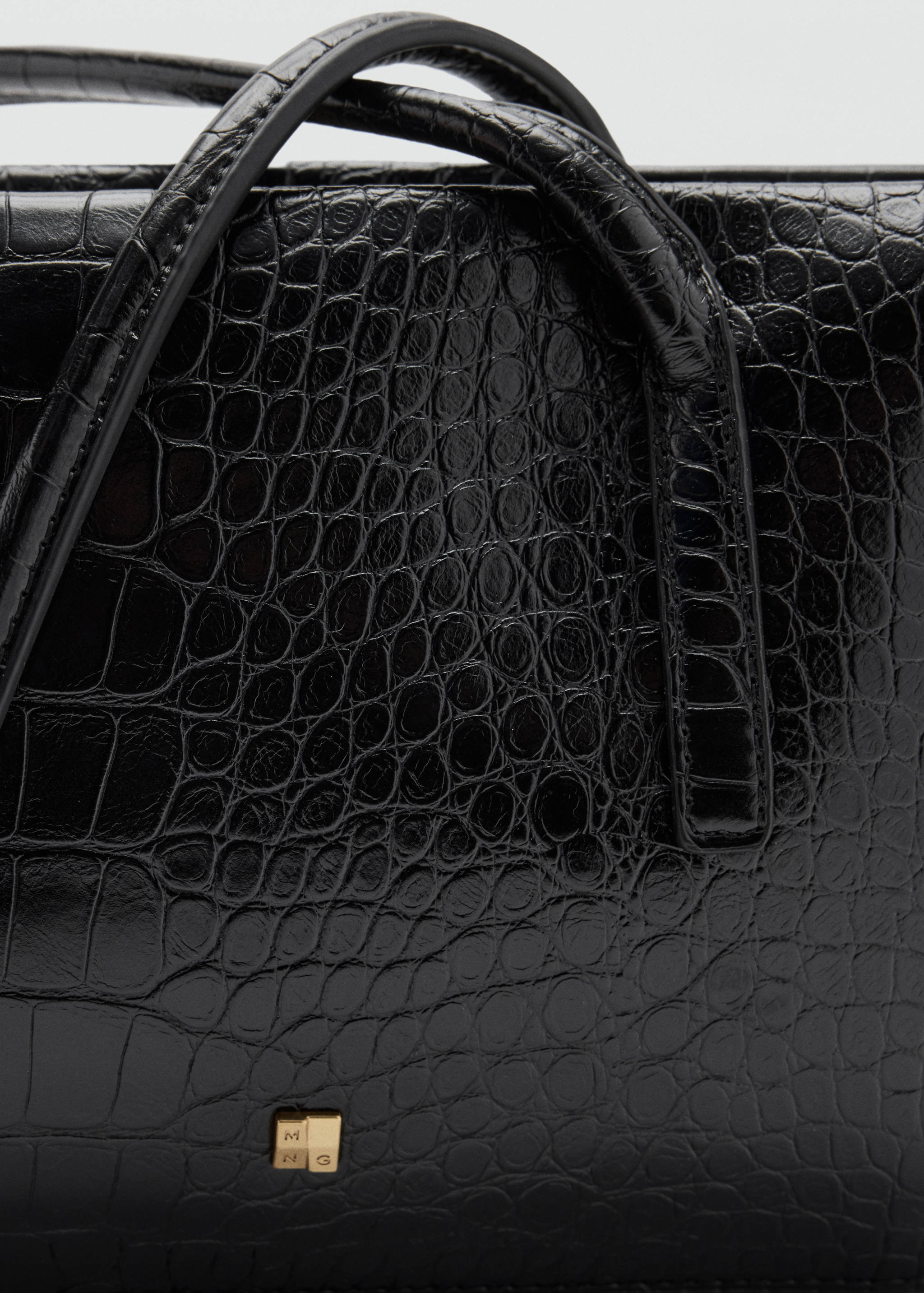 Black embossed crocodile-effect shoulder bag, detail view.