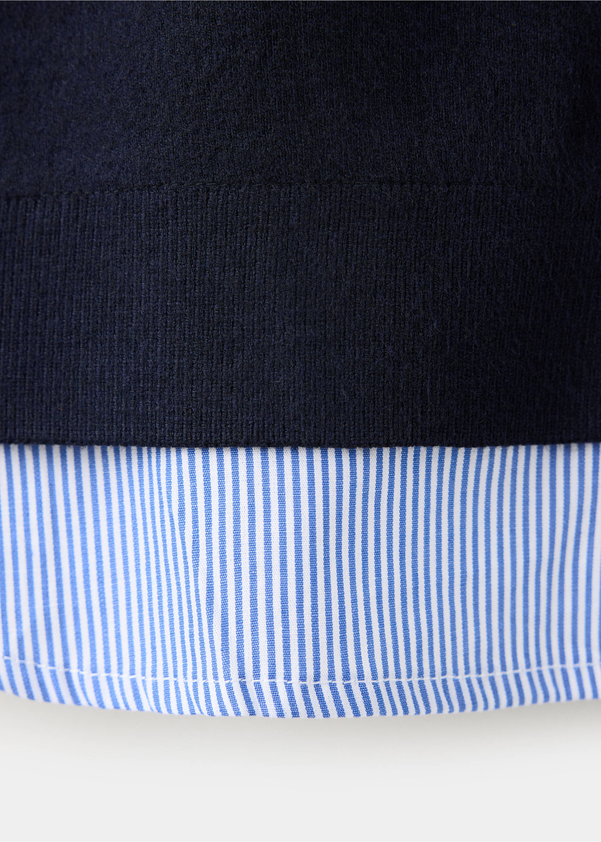 Close-up of navy knit jacket with layered striped shirt hem., Navy. Ref: 37047797-00.