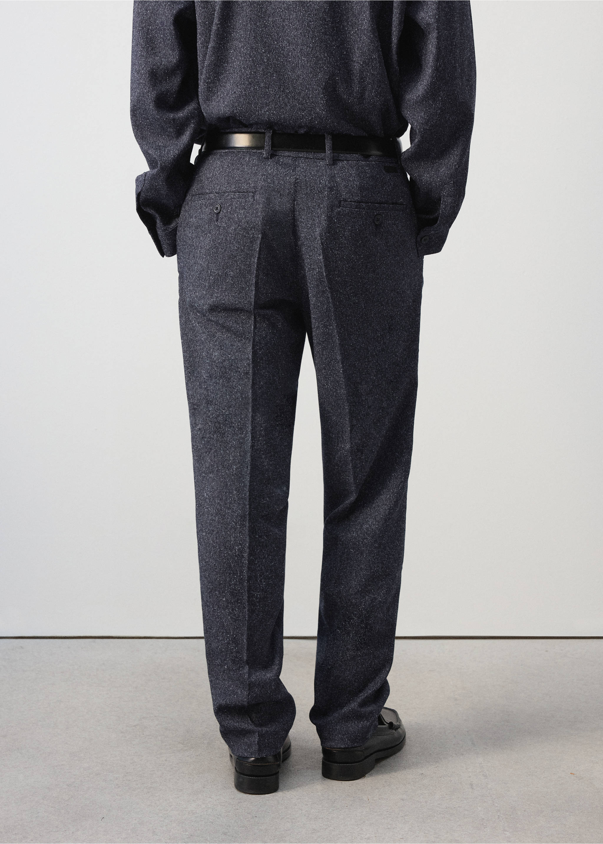 Dark grey melange trousers shown from the back, featuring a belt and back pockets., Navy. Ref: 37047885-00.