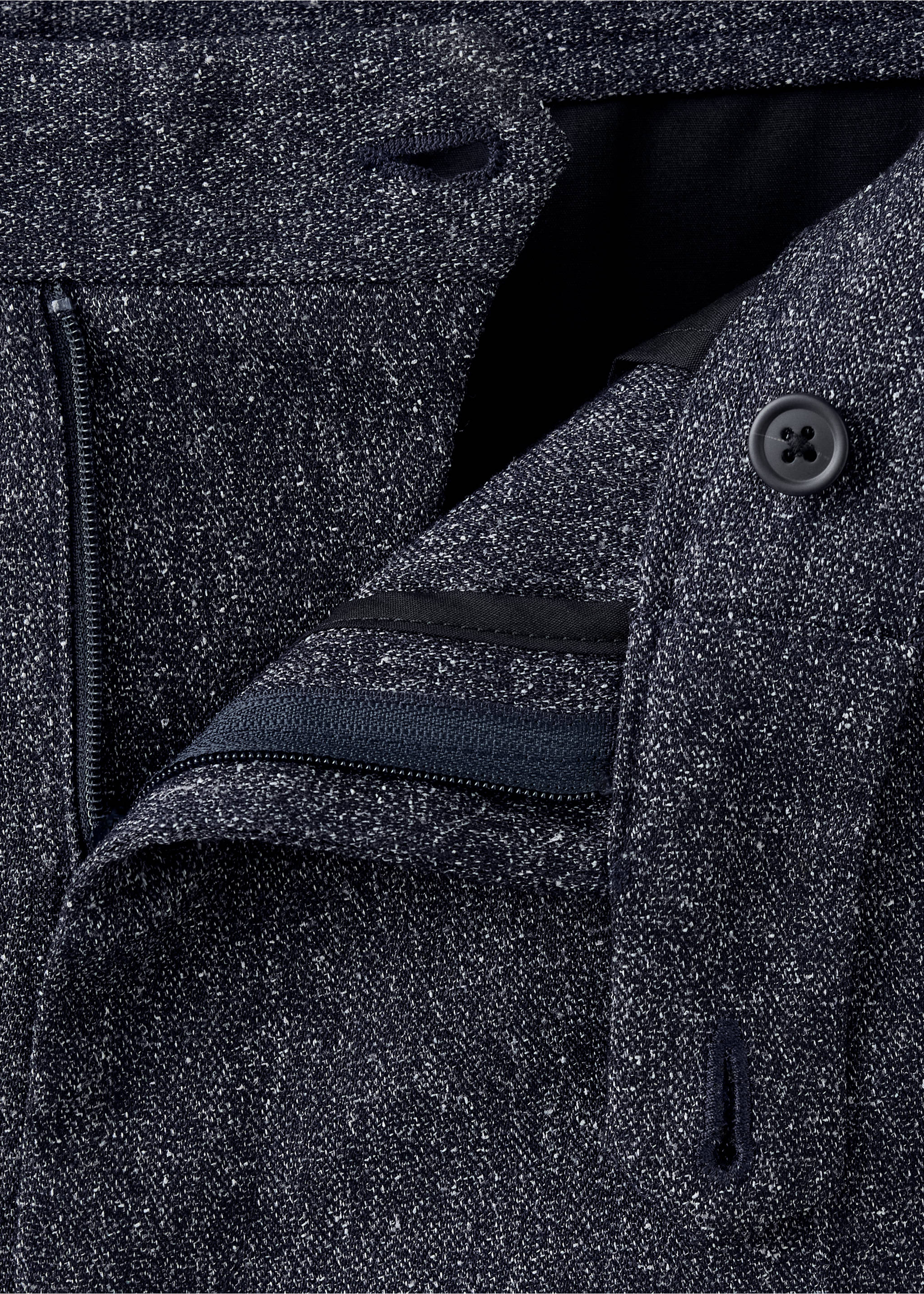 Close-up of dark navy blue textured trousers showcasing the speckled fabric, waistband, and button closure., Navy. Ref: 37047885-00.