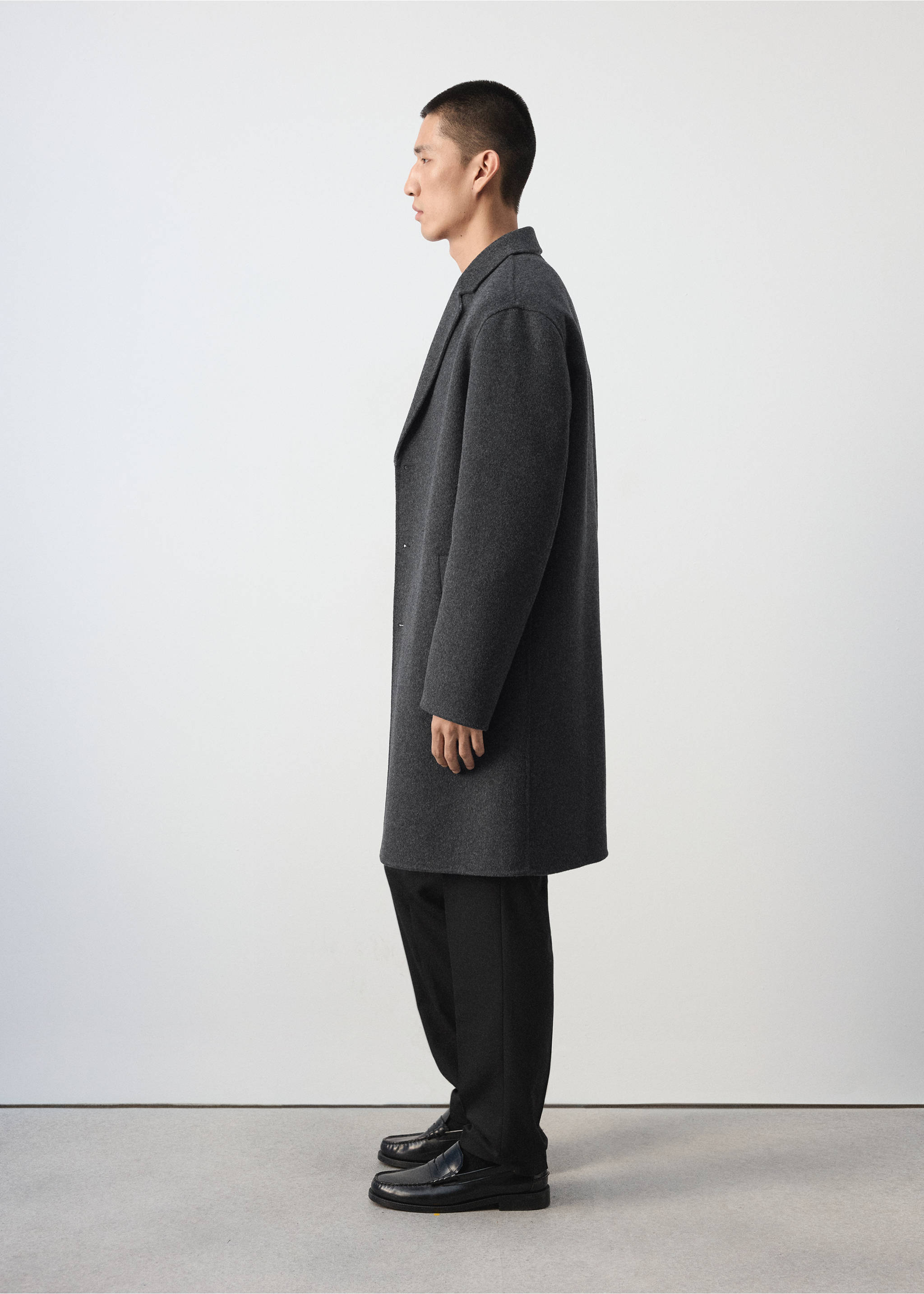 Dark grey coat with a lapel collar in a side-profile view., Charcoal. Ref: 37047886-00.