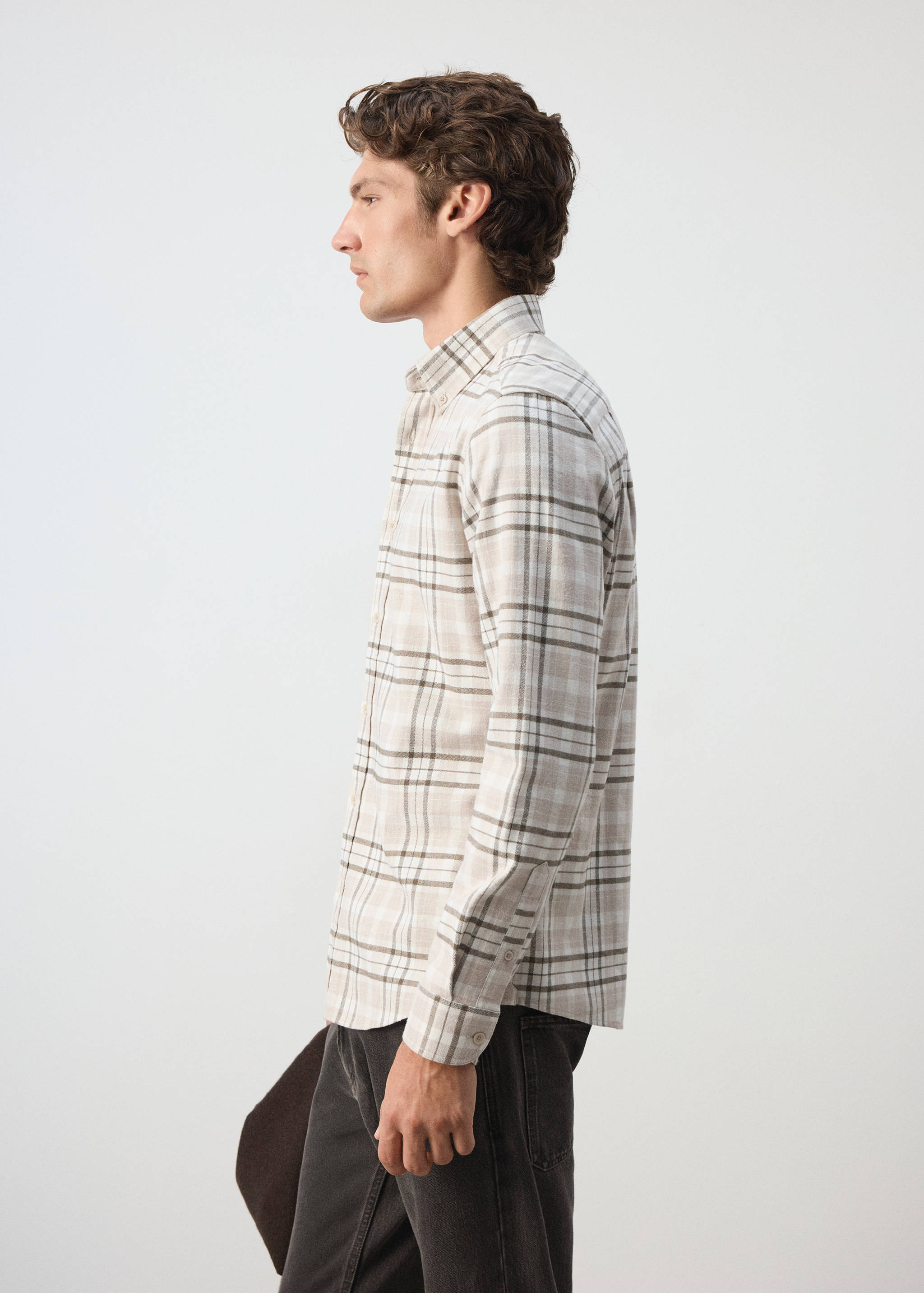 Beige plaid overshirt with a classic collar and long sleeves.
