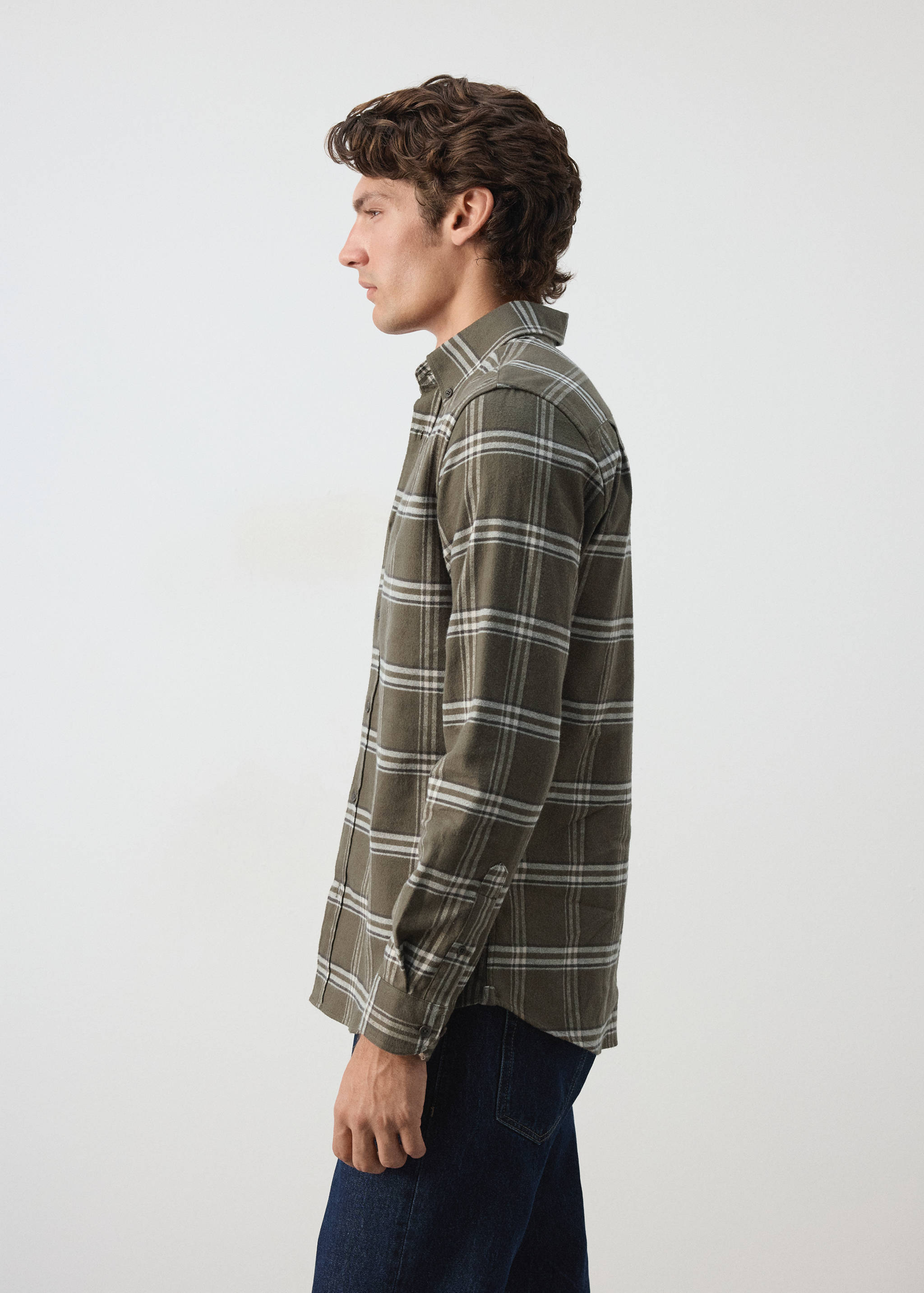 Green checked overshirt in a plaid pattern with long sleeves and a button-down collar.
