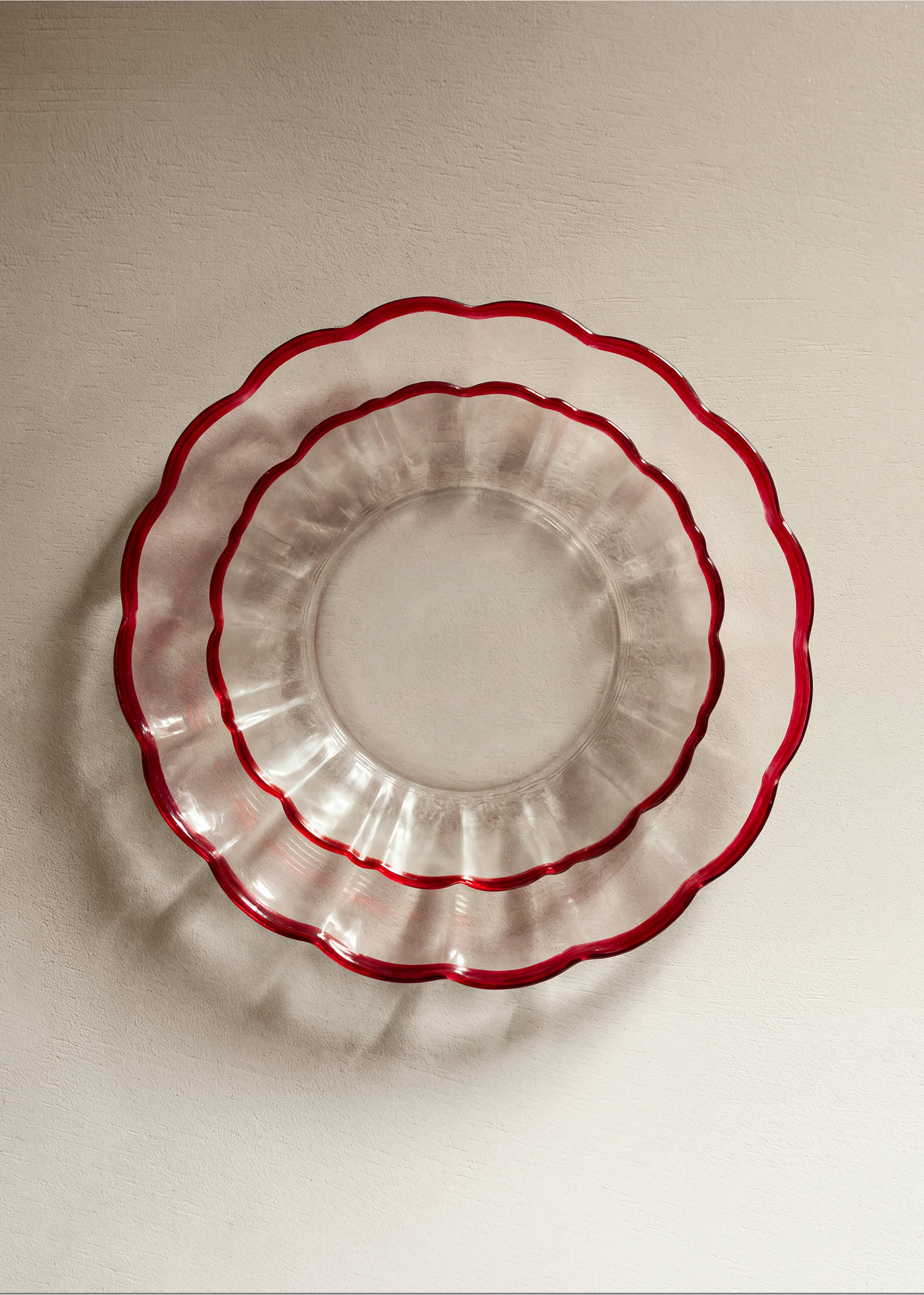 Clear glass plates with a scalloped rim and red border., Red. Ref: 37047902-00.