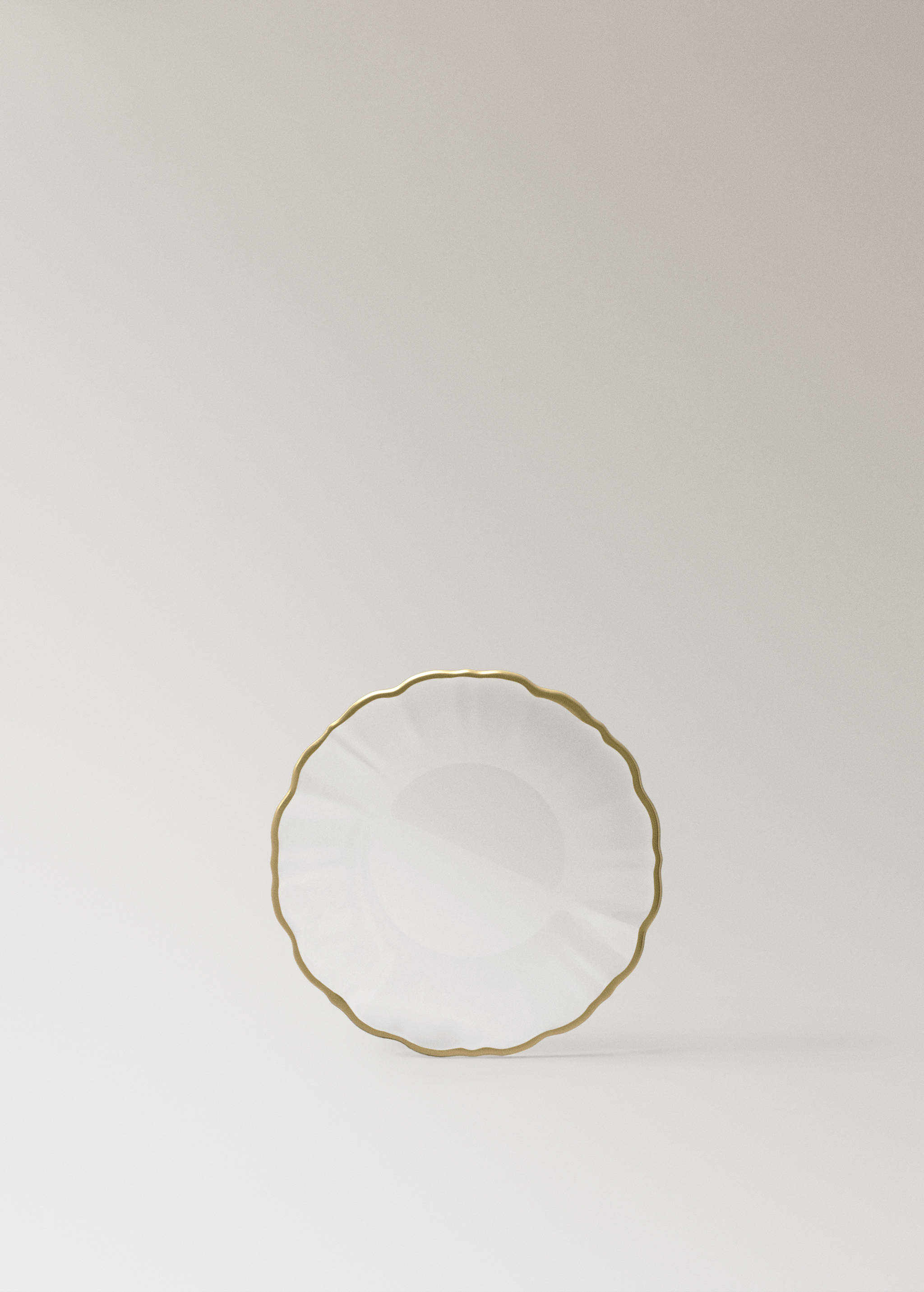 White plate with a scalloped edge and gold trim.