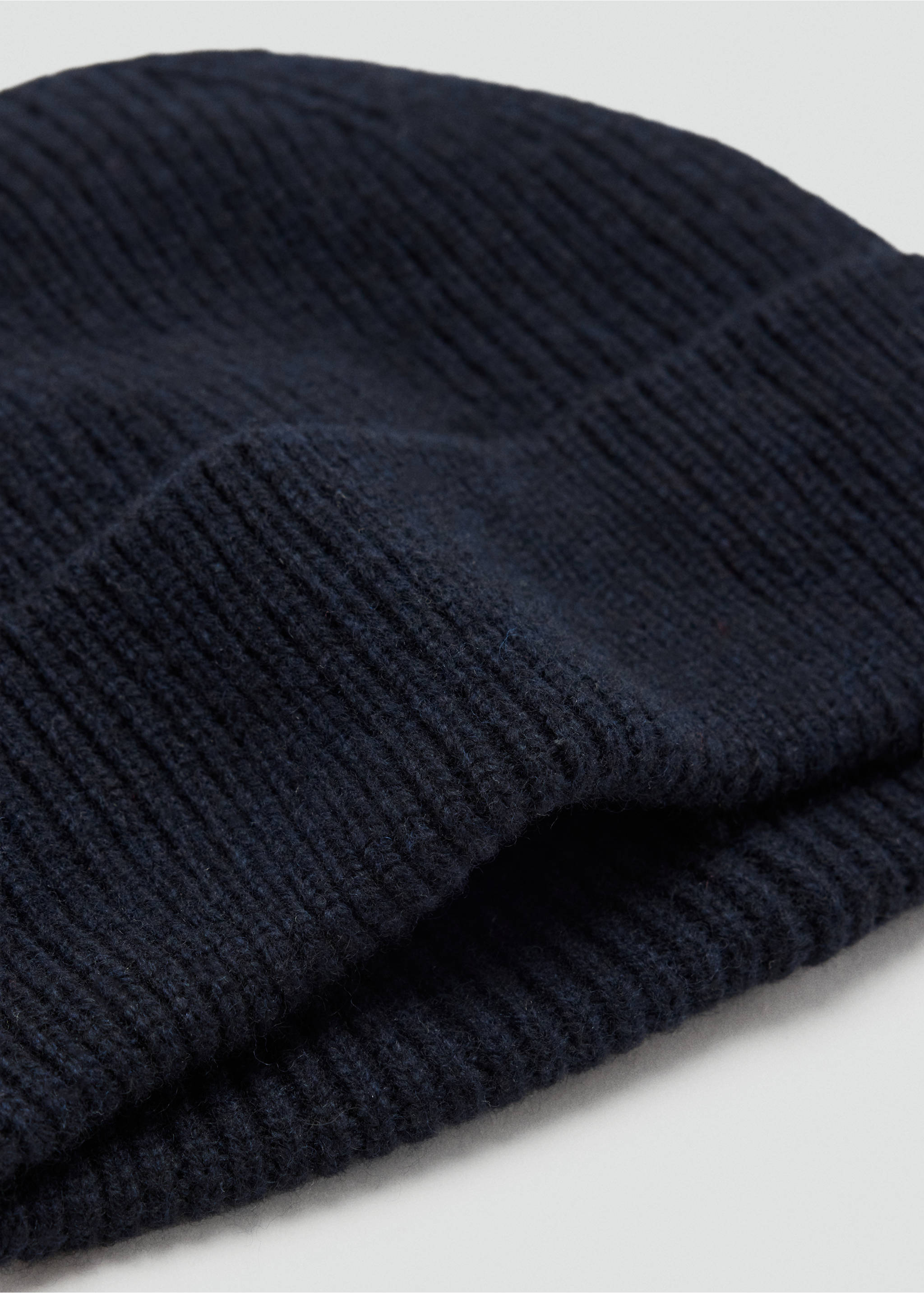 Navy blue ribbed knit beanie shown in a close-up three-quarter view., Navy. Ref: 37047903-00.