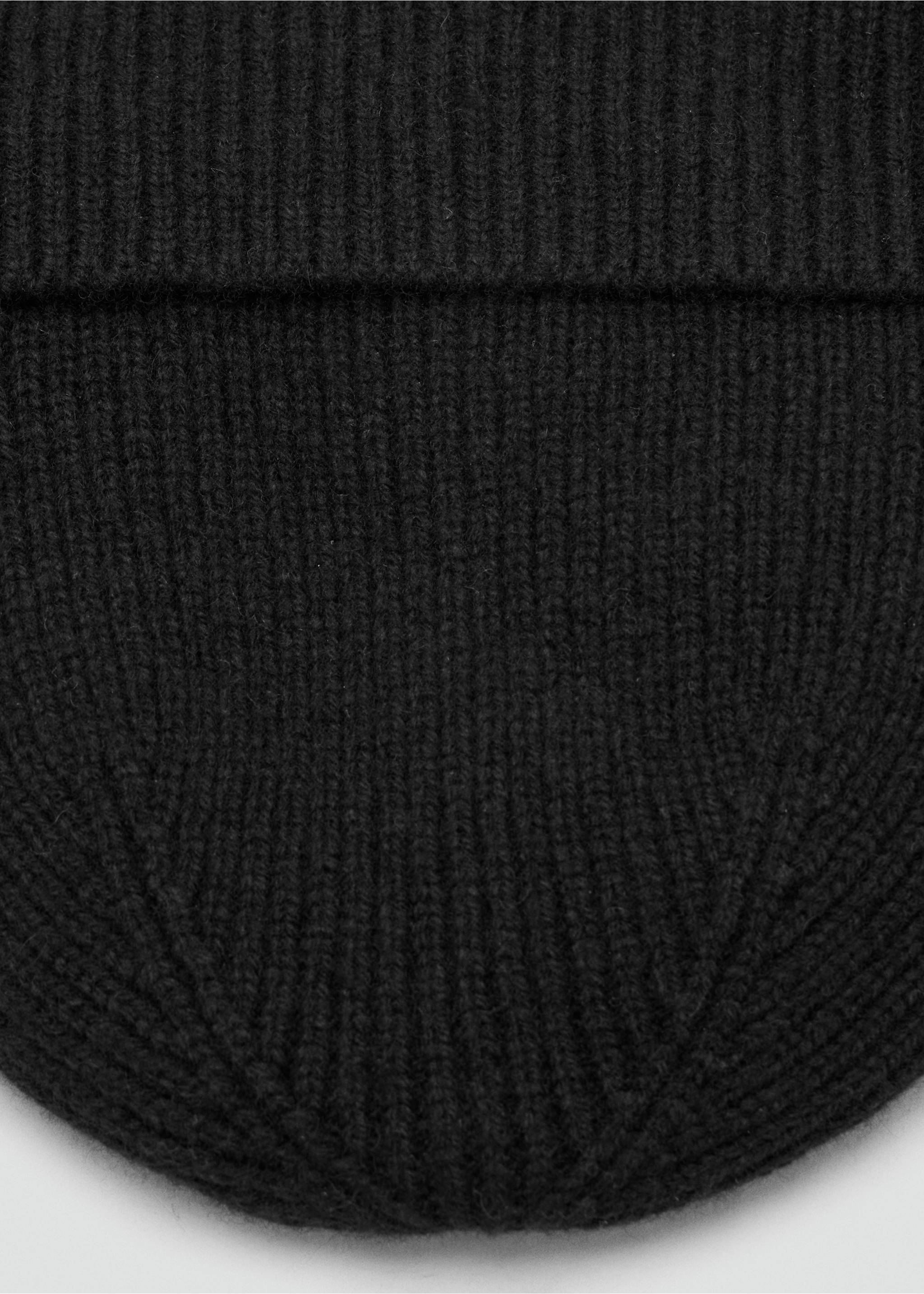 Close-up of a black ribbed knit beanie with a folded cuff., Black. Ref: 37047903-00.