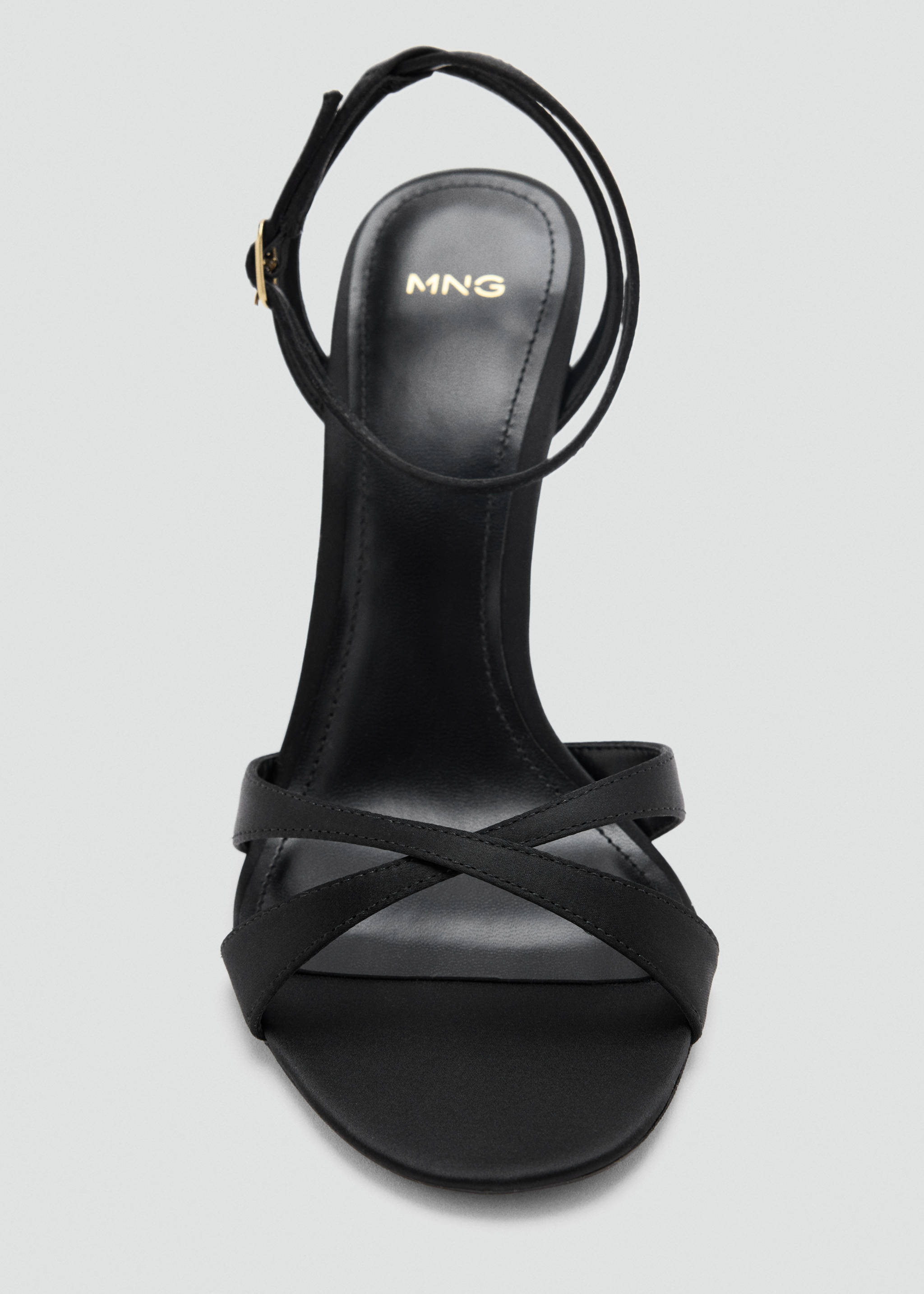 Black heeled sandal with thin cross straps and ankle fastening.