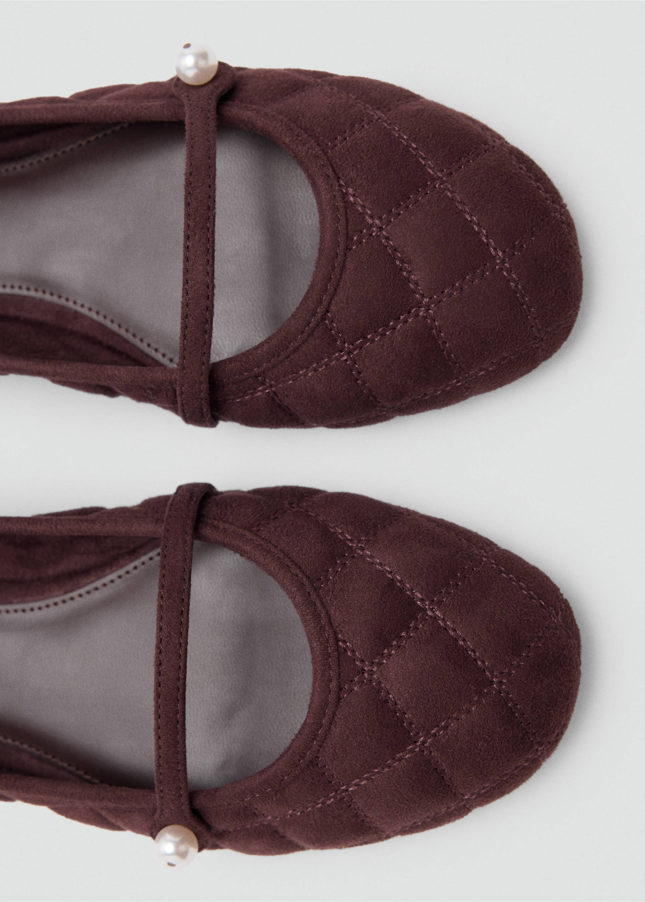 Close-up of burgundy quilted ballet flats with a thin instep strap and pearl detail., Burgundy. Ref: 37047913-00.