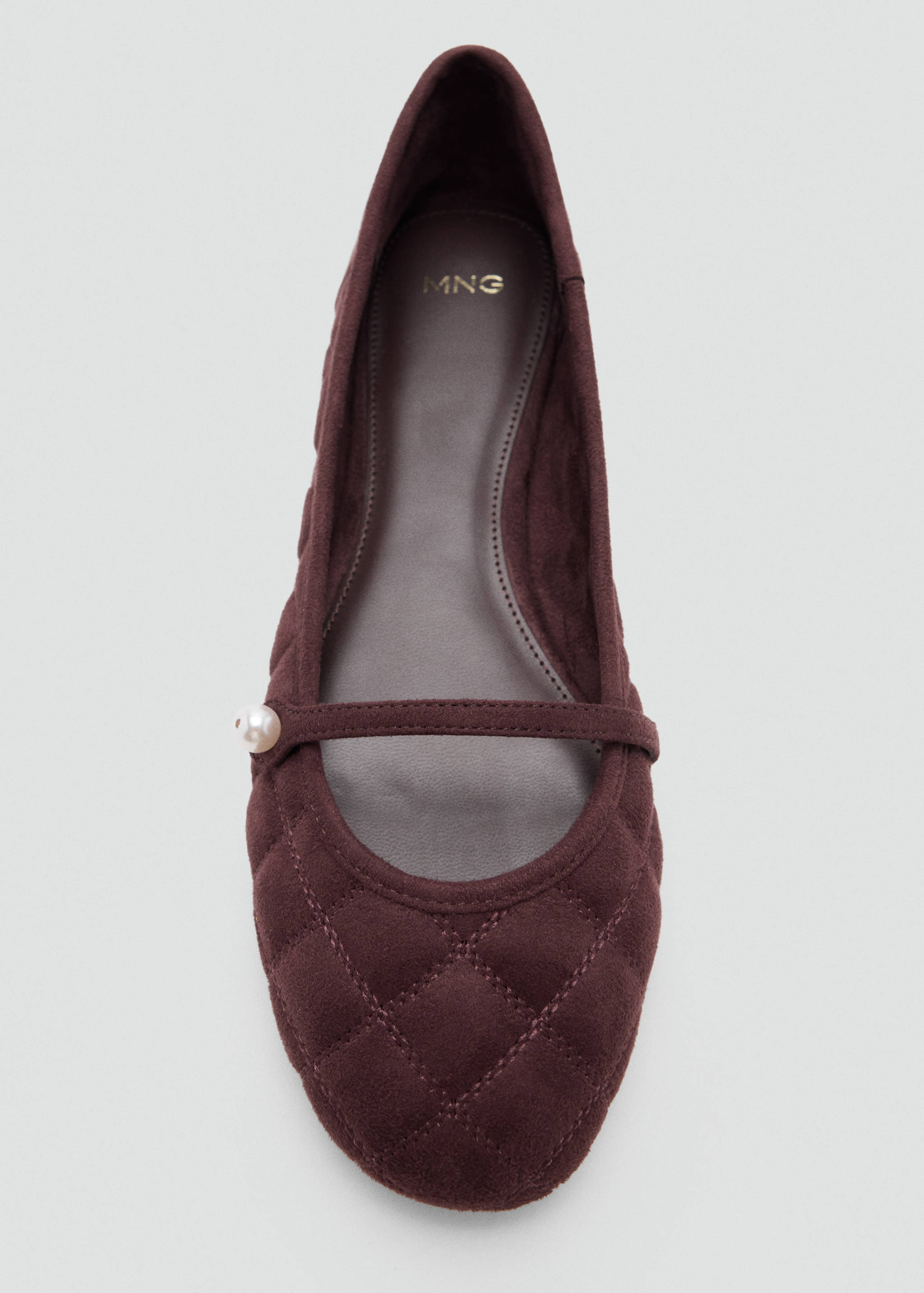 Burgundy quilted flat shoe with a strap and pearl detail.